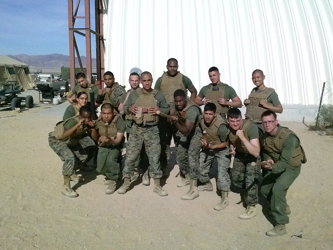 Sgt. Ryan-Michael Daffin (front row standing), an avionic technician with Marine Light Attack Helicopter Squadron (HMLA) 267, stands with his Marine Corps Martial Arts Program students after one of his sessions aboard Marine Corps Air-Ground Combat Center Twentynine Palms, Calif., Jan. 28.   Daffin mentored more than 300 Marines utilizing the martial arts program as his teaching aid.