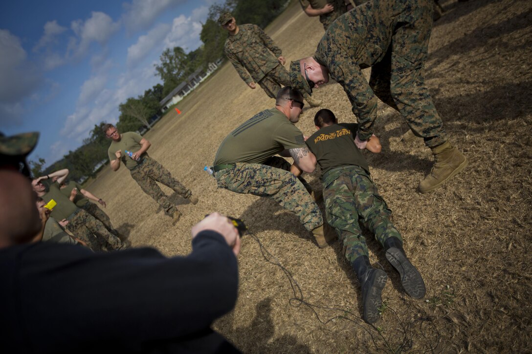 A Royal Thai Marine recieves an electric shock from a taser while participating in a non-lethal weapons training demonstration during Exercise Cobra Gold 2014 at Samaesan Royal Thai Marine Base, Rayong, Kingdom of Thailand. Cobra Gold, in its 33rd iteration, demonstrates the U.S. and the Kingdom of Thailand's commitment to our long-standing alliance and regional partnership, prosperity and security in the Asia-Pacific region. The demonstration was held by the U.S. Marines of 3rd Platoon, Company A, 3d Law Enforcement Battalion, 3d Marine Division, III Marine Expeditionary Force for the Royal Thai Marines of 1st infantry Battalion. 