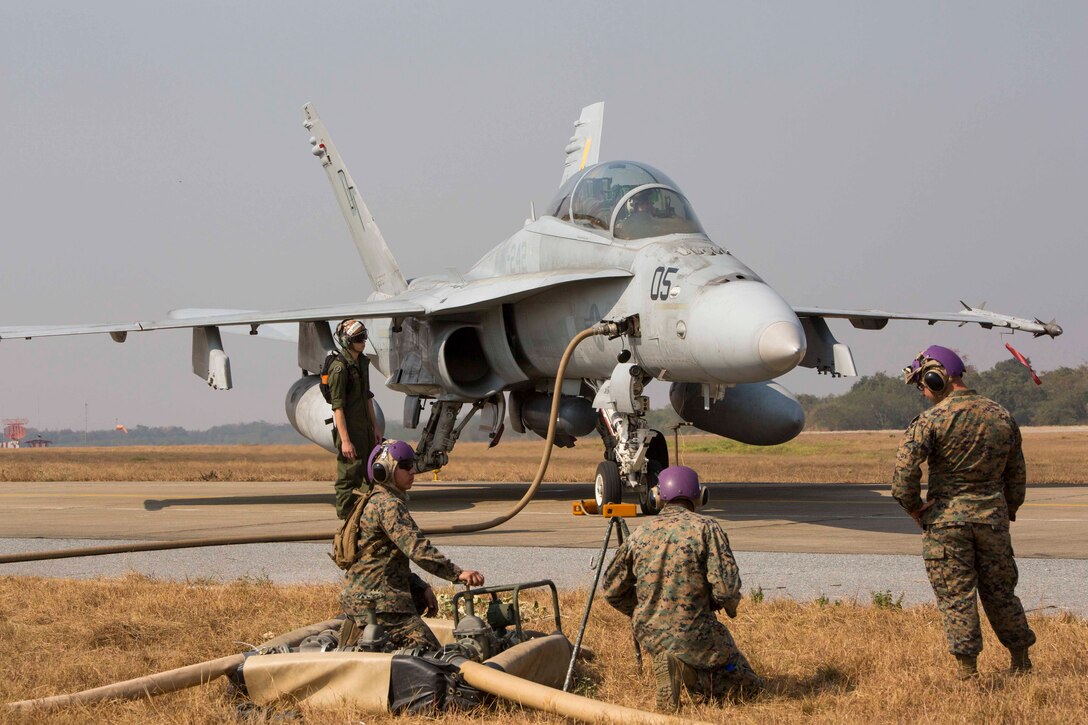 Marines pump fuel for an FA-18D Hornet at Wing One Royal Thai Air Force Base, Nakhon Ratchasima, Kingdom of Thailand, Feb. 6 in preparation for Exercise Cobra Gold 2014. CG 14 is a joint, multinational exercise conducted annually in the Kingdom of Thailand aimed at increasing readiness and interoperability of the Thai, U.S. and other fully participating military forces. The Marines are with Marine Wing Support Squadron 171, Marine Aircraft Group 12, 1st Marine Aircraft Wing, III Marine Expeditionary Force. The aircraft is with Marine All Weather Fighter Attack Squadron 242, MAG-12.