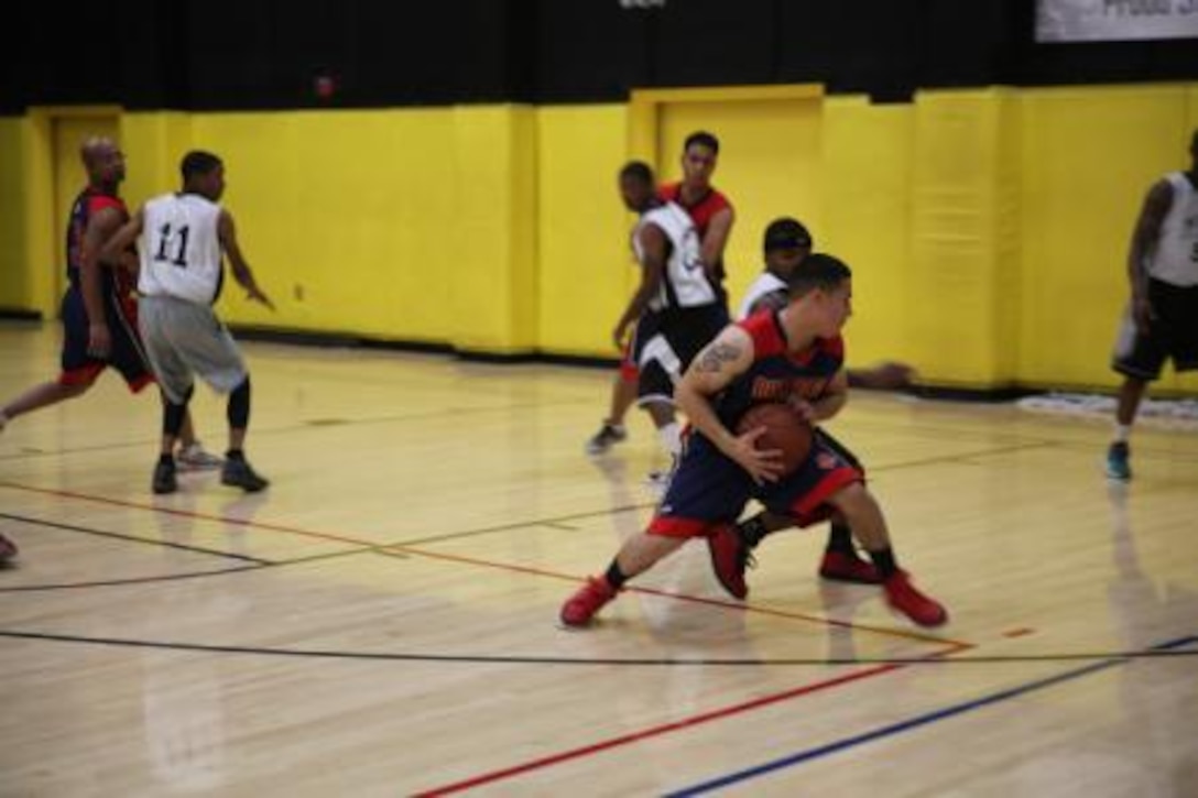 Lance Corporal Quinn Trujeque, adjutant clerk on Marine Corps Logistics Base Barstow, Calif., protects the ball during a basketball game against a National Training Center Fort Irwin basketball team, Feb. 5. MCLB Barstow’s Bulldogs started their season, Feb. 3.


