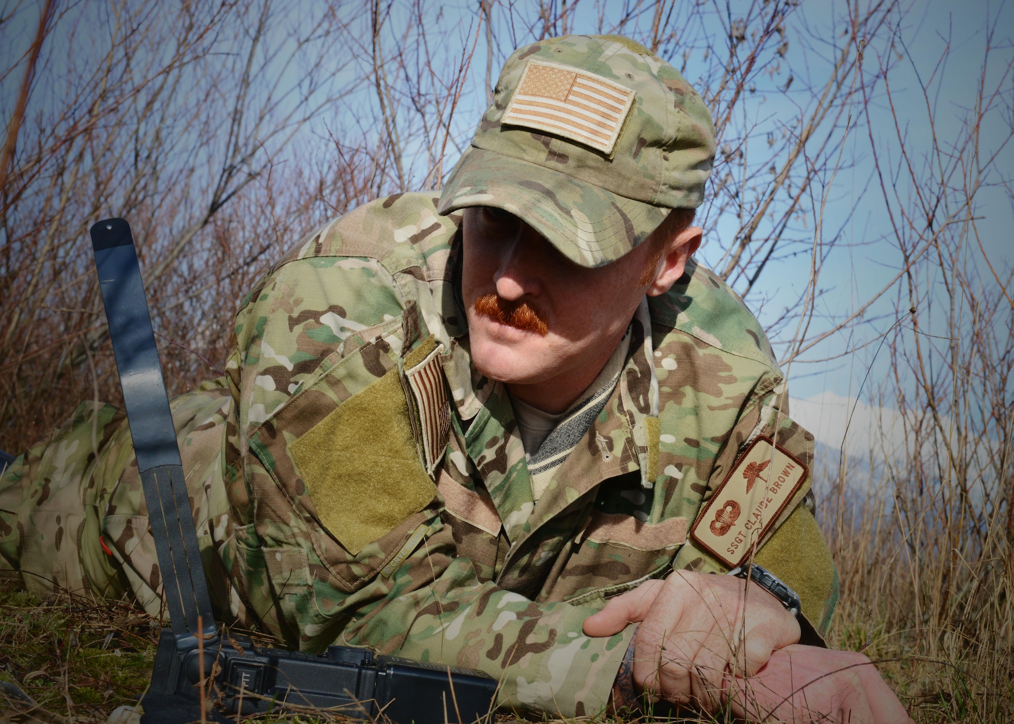 Staff Sgt. Claude Brown, 31st Operations Support Squadron survival, evasion, recovery and escape specialist, waits for a radio response from 31st Fighter Wing pilots during a simulated combat search and rescue mission, Jan. 28, 2014, at Cellina Meduna training ground near Maniago, Italy. (U.S. Air Force photo/Airman 1st Class Ryan Conroy) 
