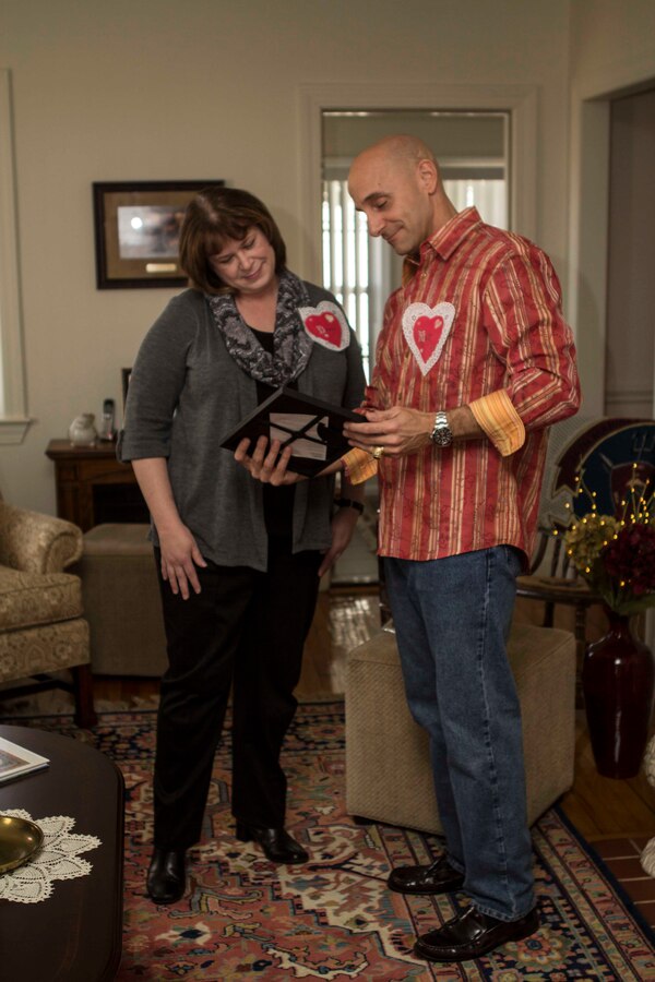 Col. Matthew G. St. Clair, 26th Marine Expeditionary Unit (MEU) commanding officer, presents a plaque of recognition to a volunteer during a get together to recognize efforts of family readiness volunteers, the link between deployed Marines, spouses and children left behind during the 26th MEU's latest deployment, Feb. 7, 2014. (U.S. Marine Corps photo by Cpl. Michael S. Lockett/Released)