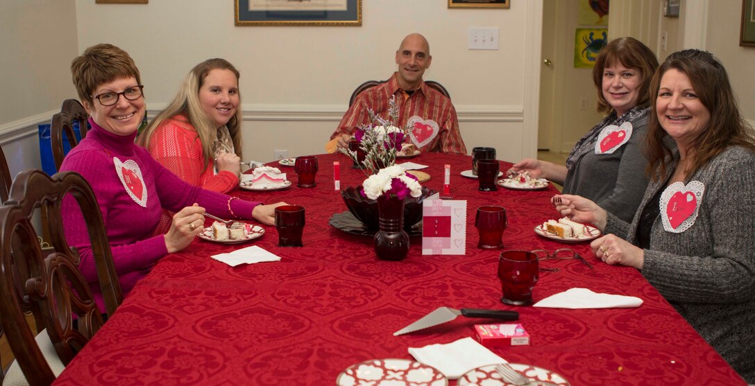 Col. Matthew G. St. Clair, 26th Marine Expeditionary Unit (MEU) commanding officer, sits down to enjoy a slice of cake during a get together to recognize efforts of family readiness volunteers, the link between deployed Marines, spouses and children left behind during the 26th MEU's latest deployment, Feb. 7, 2014. (U.S. Marine Corps photo by Cpl. Michael S. Lockett/Released)