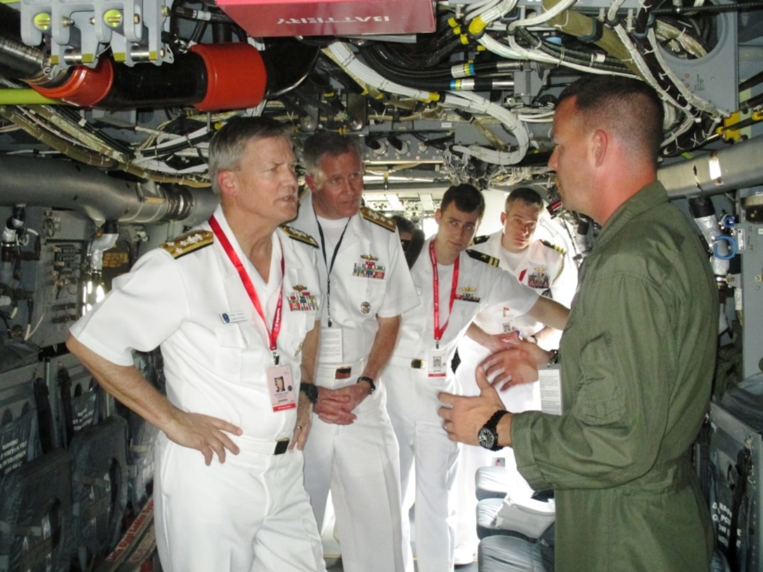 U.S. Marine Capt. Christopher Demars, of Wilson, N.C., briefs Vice Adm. Robert Thomas, commander, U.S. 7th Fleet, on the capabilities of the MV-22B Osprey at Changi Air Base Feb. 13 during the Singapore International Airshow 2014. The Singapore Air Show 2014 helps build stronger relations between the U.S. and Singapore, as well as among the international community. The event promotes military to military discussions on aircraft and equipment, which enables greater interoperability of aviation platforms, and furthers international military relationships and cooperation. The U.S. is committed to maintaining peace and stability in the region, and this event demonstrates a focus of the U.S. rebalance to the Asia-Pacific region. Demars is an MV-22B Osprey pilot, and the squadron is part of Marine Air Group 36, 1st Marine Aircraft Wing, III Marine Expeditionary Force. (U.S. Marine Corps photo by Capt. Caleb D. Eames/Released)