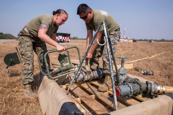 Pfc. Meagan Quinn, left, and Lance Cpl. Erik Campos attach a meter to a fuel point Feb. 2 at Wing One Royal Thai Air Force Base, Nakhon Ratchasima, Kingdom of Thailand in preparation for Exercise Cobra Gold 2014. CG 14 is a joint, multinational exercise conducted annually in the Kingdom of Thailand aimed at increasing readiness and interoperability of the Thai, U.S. and other fully participating military forces. Quinn and Campos are bulk fuels specialists with Marine Wing Support Squadron 171, Marine Aircraft Group 12, 1st Marine Air Wing, III Marine Expeditionary Force.