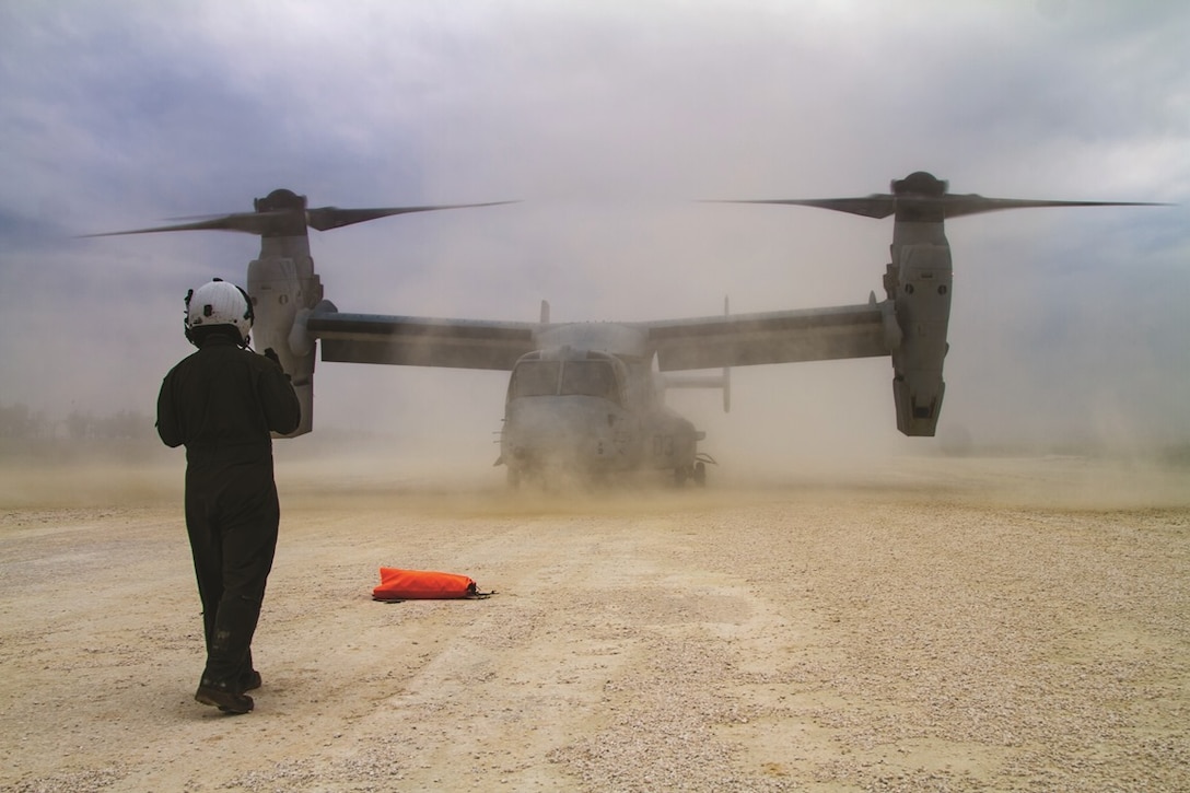 A Marine guides an MV-22B Osprey into position to be refueled during aviation delivered ground refueling operations training Feb. 5 at Ie Shima Training Facility, Okinawa, Japan. The ADGR system pumps fuel from internal mission auxiliary tanks that can carry more than 2,000 pounds of fuel. The Marines are with Marine Medium Tiltrotor Squadron 265 (Reinforced), Aviation Combat Element, 31st Marine Expeditionary Unit, Marine Aircraft Group 36, 1st Marine Aircraft Wing, III Marine Expeditionary Force.