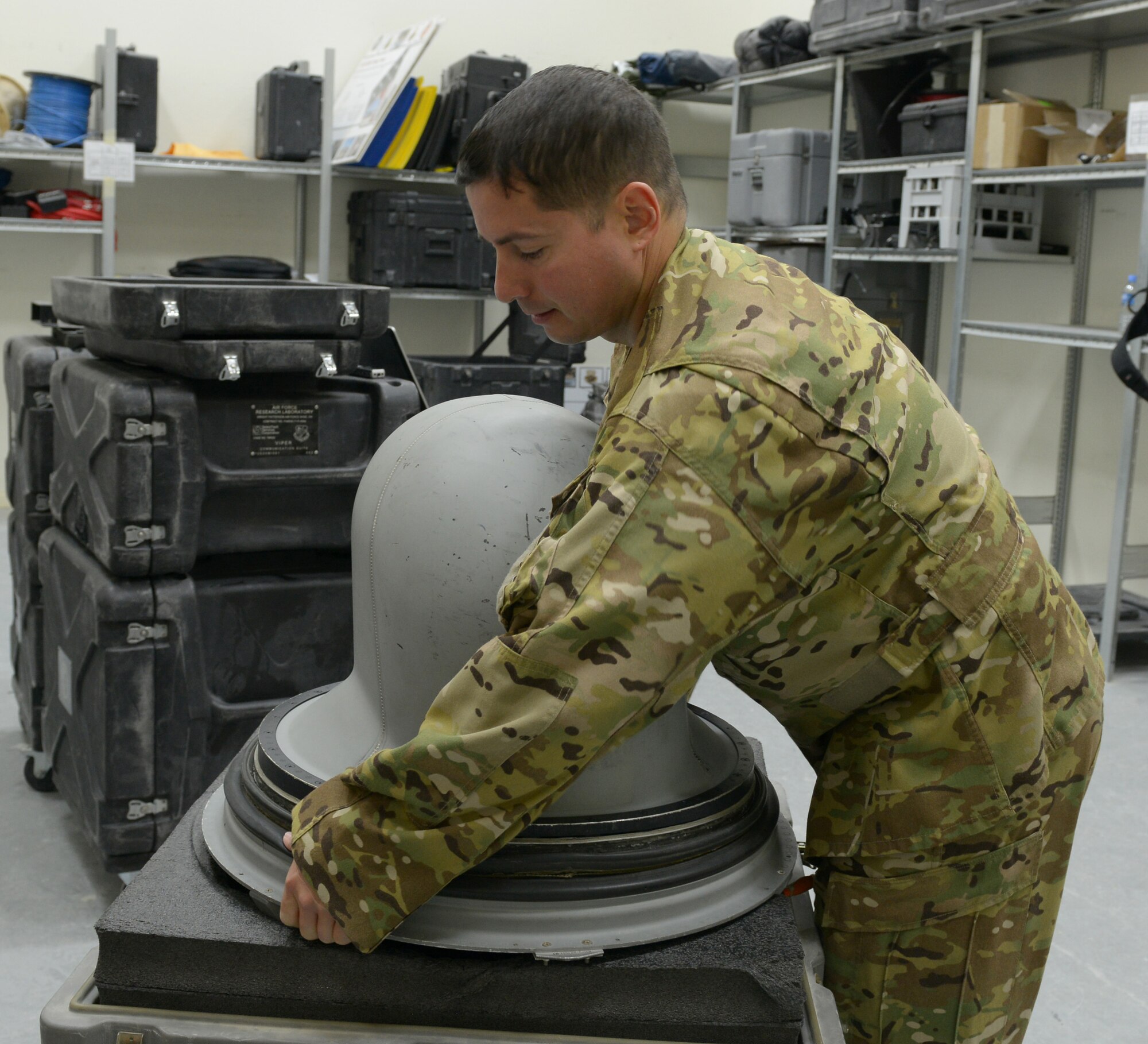 Tech. Sgt. Kevin Fossett inspects an airborne communications antenna to ensure it is operational before a mission at Al Udeid Air Base, Qatar, Feb. 12, 2014. The 379th Expeditionary Communications Squadron's Viper Team is made up of six Airmen and on call 24/7 to provide airborne communication throughout the U.S. Air Forces Central Command area of responsibility. Fossett is a 379th ECS Viper team airborne communications specialist deployed from Joint Base Pearl Harbor-Hickam, Hawaii, and a Milford, Conn., native. (U.S. Air Force photo/Senior Airman Hannah Landeros) 