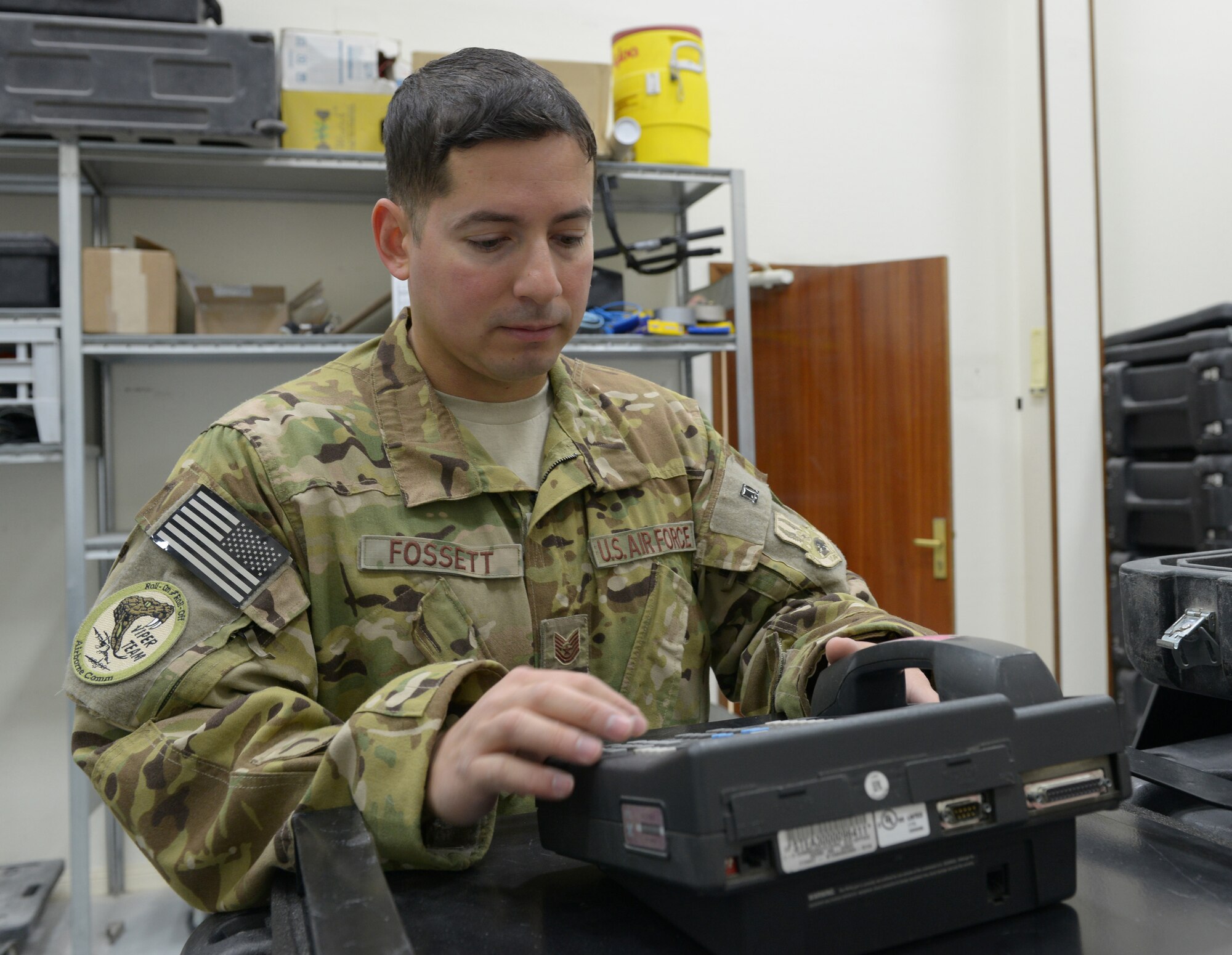 Tech. Sgt. Kevin Fossett prepares to inspect a classified phone at Al Udeid Air Base, Qatar, Feb. 12, 2014. The 379th Expeditionary Communications Squadron's Viper Team is made up of six Airmen and on call 24/7 to provide airborne communication throughout the U.S. Air Forces Central Command area of responsibility. Fossett is a 379th ECS Viper team airborne communications specialist deployed from Joint Base Pearl Harbor-Hickam, Hawaii, and a Milford, Conn., native. (U.S. Air Force photo/Senior Airman Hannah Landeros) 