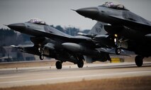 Two F-16 Fighting Falcons from the 35th Fighter Squadron land in sync after a training sortie at Kunsan Air Base, Republic of Korea, Feb. 13, 2014. The Wolf Pack ensures readiness by presenting pilots with different training scenarios to further reinforce the Wolf Pack’s ability to fight tonight. (U.S. Air Force photo by Senior Airman Armando A. Schwier-Morales/Released) 