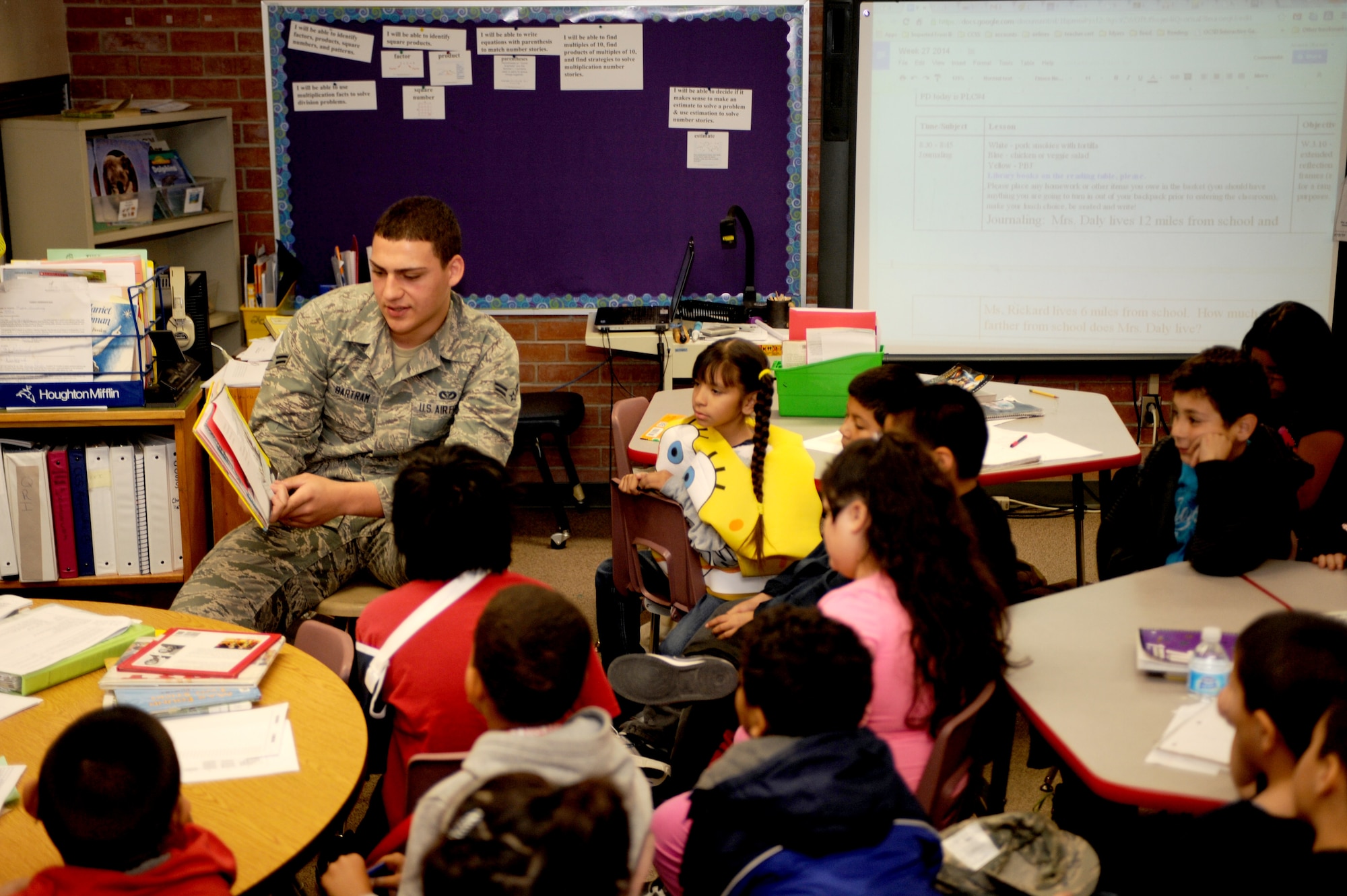 U.S. Air Force Airman 1st Class James Bartram, 355th Civil Engineer Squadron firefighter, reads “One Fish Two Fish Red Fish Blue Fish” by Dr. Seuss, to a 3rd-grade class during Love of Reading Week at Myers-Ganoung Elementary School in Tucson, Ariz., Feb. 12, 2014. Love of Reading Week is a national event designed to encourage students and adults to read. (U.S. Air Force photo by Airman 1st Class Cheyenne Morigeau/ Released)