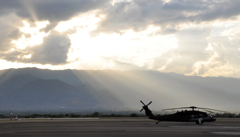 A UH-60 Blackhawk helicopter assigned to Joint Task Force-Bravo's 1-228th Aviation regiment sits on the flightline as the sun sets at Soto Cano Air Base, Honduras, Feb. 12, 2014. Joint Task Force-Bravo utilizes UH-60 and CH-47 aircraft to execute a wide variety of mission sets in order to work with our Honduran host-nation partners to enhance regional security, stability, and cooperation. (U.S. Air Force photo by Capt. Zach Anderson)