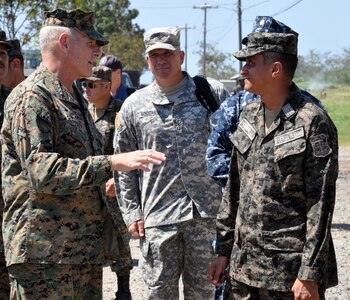 U.S. Marine Corps Gen. John F. Kelly, Commander, U.S. Southern Command, visits with a member of the Honduran navy while touring a Honduran naval base at Puerto Castilla, Honduras, Feb. 12, 2014.  Kelly and a delegation of U.S. Department of State and U.S. and Honduran military leaders, including U.S. Ambassador to Honduras Lisa Kubiske, Honduran Maj. Gen. Fredy Diaz, Joint Chief of the Honduran Military, and Honduran Rear Admiral Hector Caballero, Honduran Navy Commander, spent the day visiting several Honduran military facilities. Throughout the day, the delegation received briefings and had the opportunity to discuss issues with Honduran military leadership. Transportation for the day was provided by UH-60 Blackhawk helicopters from Joint Task Force-Bravo's 1-228th Aviation Regiment. (U.S. Air Force photos by Capt. Zach Anderson)