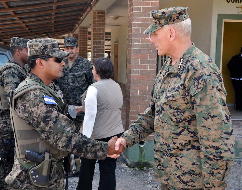 U.S. Marine Corps Gen. John F. Kelly, Commander, U.S. Southern Command, visits with a member of the Honduran military while touring a Honduran marine base at La Ceiba, Honduras, Feb. 12, 2014.  Kelly and a delegation of U.S. Department of State and U.S. and Honduran military leaders, including U.S. Ambassador to Honduras Lisa Kubiske, Honduran Maj. Gen. Fredy Diaz, Joint Chief of the Honduran Military, and Honduran Rear Admiral Hector Caballero, Honduran Navy Commander, spent the day visiting several Honduran military facilities. Throughout the day, the delegation received briefings and had the opportunity to discuss issues with Honduran military leadership. Transportation for the day was provided by UH-60 Blackhawk helicopters from Joint Task Force-Bravo's 1-228th Aviation Regiment. (U.S. Air Force photos by Capt. Zach Anderson)