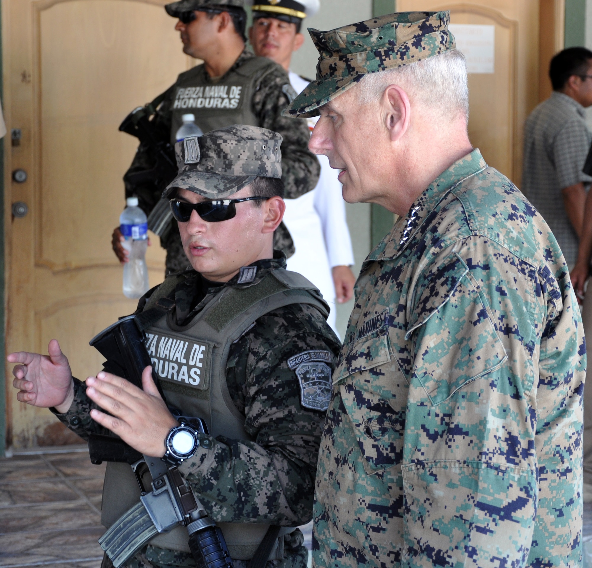 U.S. Marine Corps Gen. John F. Kelly, Commander, U.S. Southern Command, visits with a member of the Honduran military while touring a Honduran Naval installation at La Ceiba, Honduras, Feb. 12, 2014.  Kelly and a delegation of U.S. Department of State and U.S. and Honduran military leaders, including U.S. Ambassador to Honduras Lisa Kubiske, Honduran Maj. Gen. Fredy Diaz, Joint Chief of the Honduran Military, and Honduran Rear Admiral Hector Caballero, Honduran Navy Commander, spent the day visiting several Honduran military facilities. Throughout the day, the delegation received briefings and had the opportunity to discuss issues with Honduran military leadership. Transportation for the day was provided by UH-60 Blackhawk helicopters from Joint Task Force-Bravo's 1-228th Aviation Regiment. (U.S. Air Force photos by Capt. Zach Anderson)