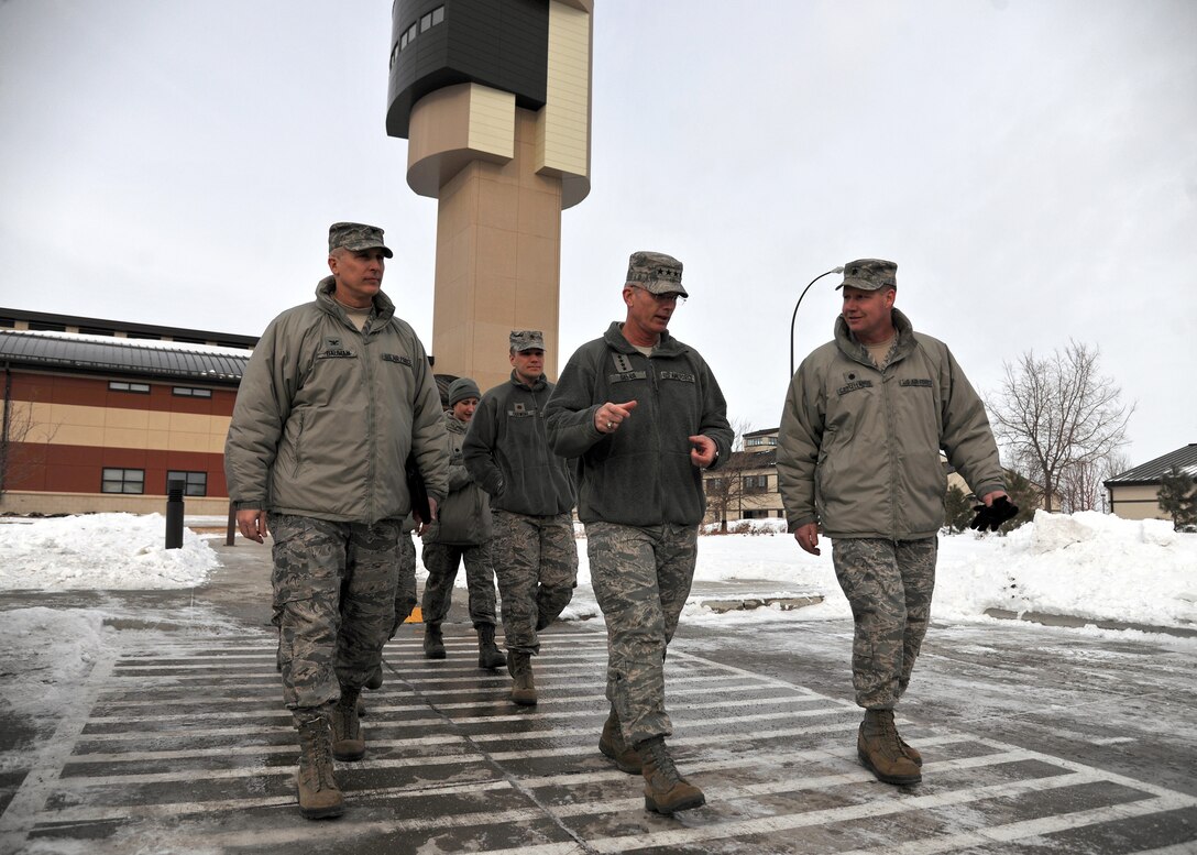 Col. Paul Bauman, 319th Air Base Wing commander (left), Gen. Paul Selva, Air Mobility Command commander, and Lt. Col. Jonathan Castellanos, 319th Operations Support Squadron commander(right), discuss how the 319th OSS provides for the mission, Feb. 11, 2014, on Grand Forks Air Force Base, N.D.  The Air Traffic Control Tower tour was part of the first-day of the two-day tour of Grand Forks AFB. (U.S. Air Force photo/Senior Airman Xavier Navarro)