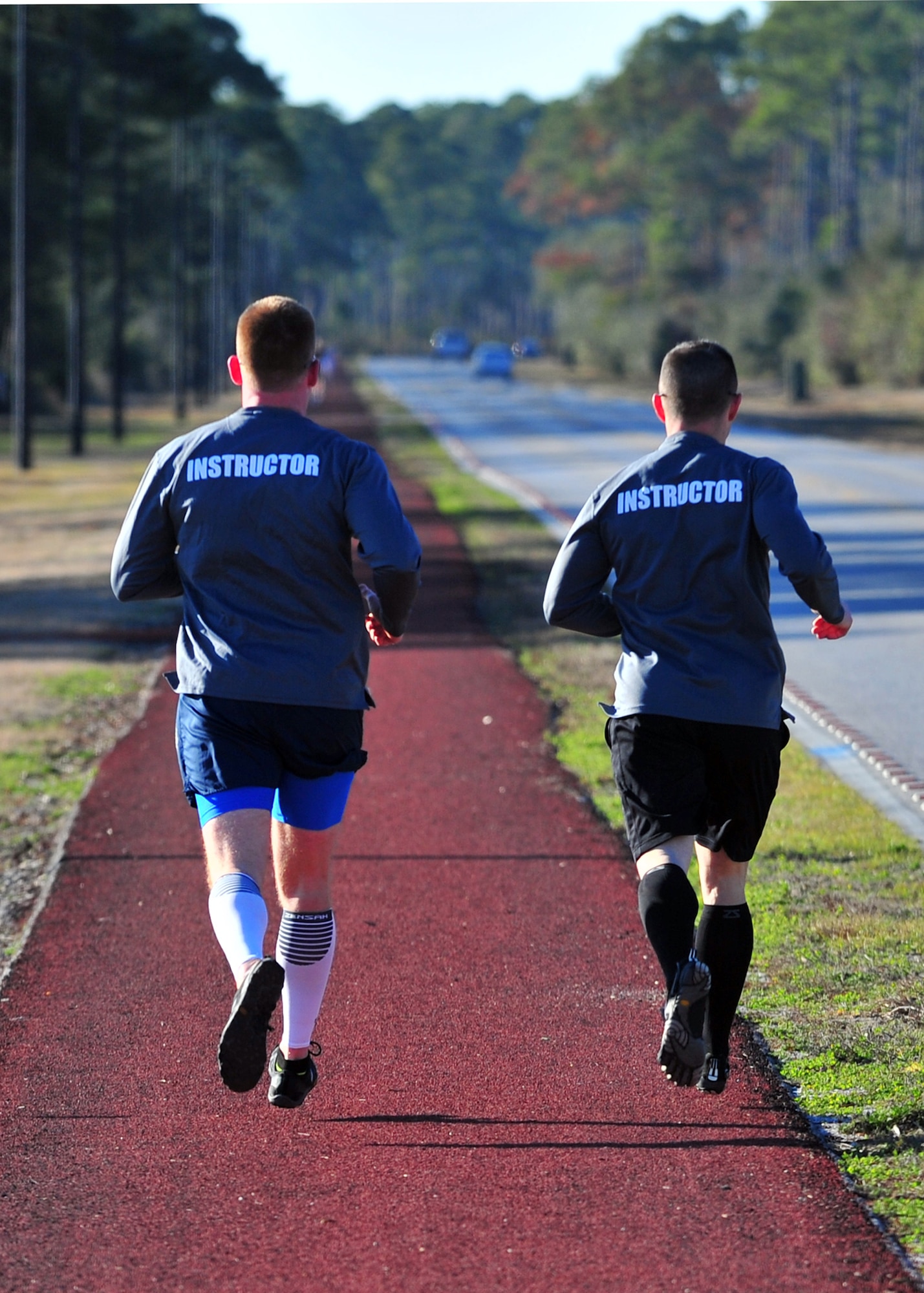 Tech. Sgt. Michael Petty and Tech. Sgt. Brandon Gremillion, 325th Force Support Squadron Airmen Leadership School instructors, go for a long run Feb. 13 along Beacon Beach rd., in preparation for the Destin 50 Beach Ultra Marathon. (U.S. Air Force photo by Airman 1st Class Sergio Gamboa)