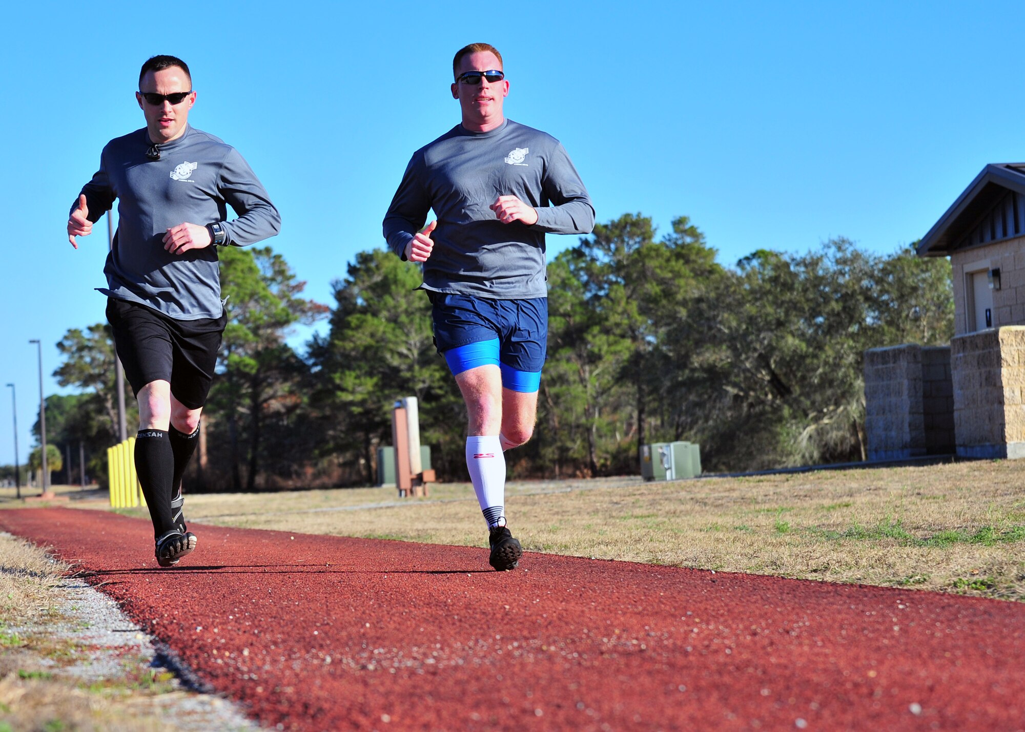 Tech. Sgt. Michael Petty and Tech. Sgt. Brandon Gremillion, 325th Force Support Squadron Airmen Leadership School instructors, go for a long run Feb. 13 along Beacon Beach rd., in preparation for the Destin 50 Beach Ultra Marathon. (U.S. Air Force photo by Airman 1st Class Sergio Gamboa)