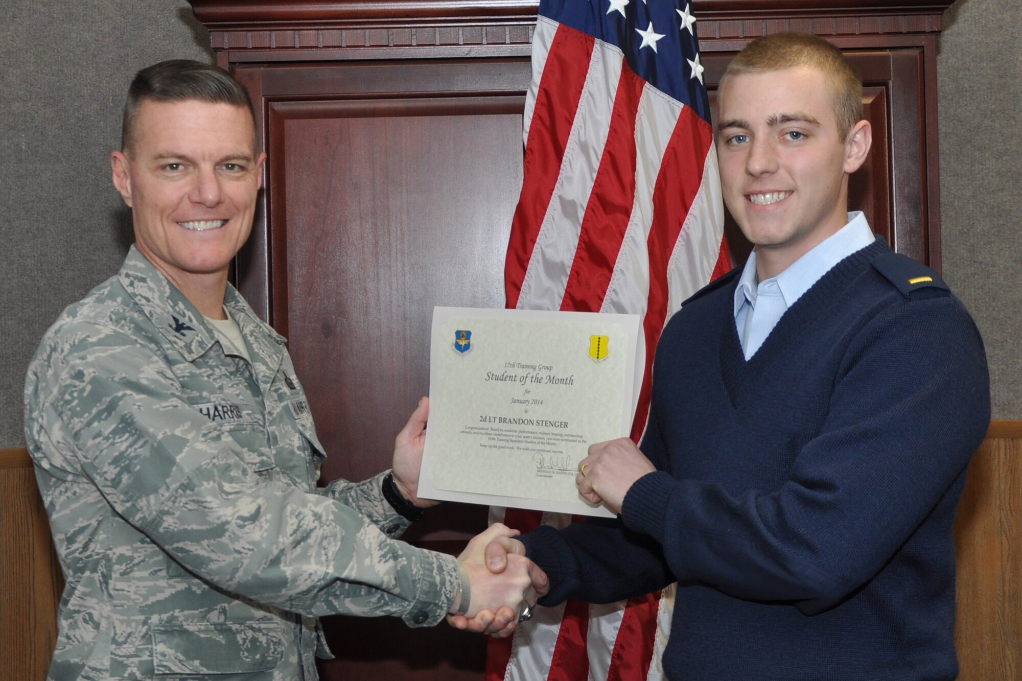 GOODFELLOW AIR FORCE BASE, Texas -- Col. Brendan Harris, 17th Training Group Commander, presents the 315th Training Squadron Officer Student of the Month award for January 2014 to 2nd Lt. Brandon Stenger, Feb. 7. (U.S. Air Force photo/Airman 1st Class Breonna Veal)