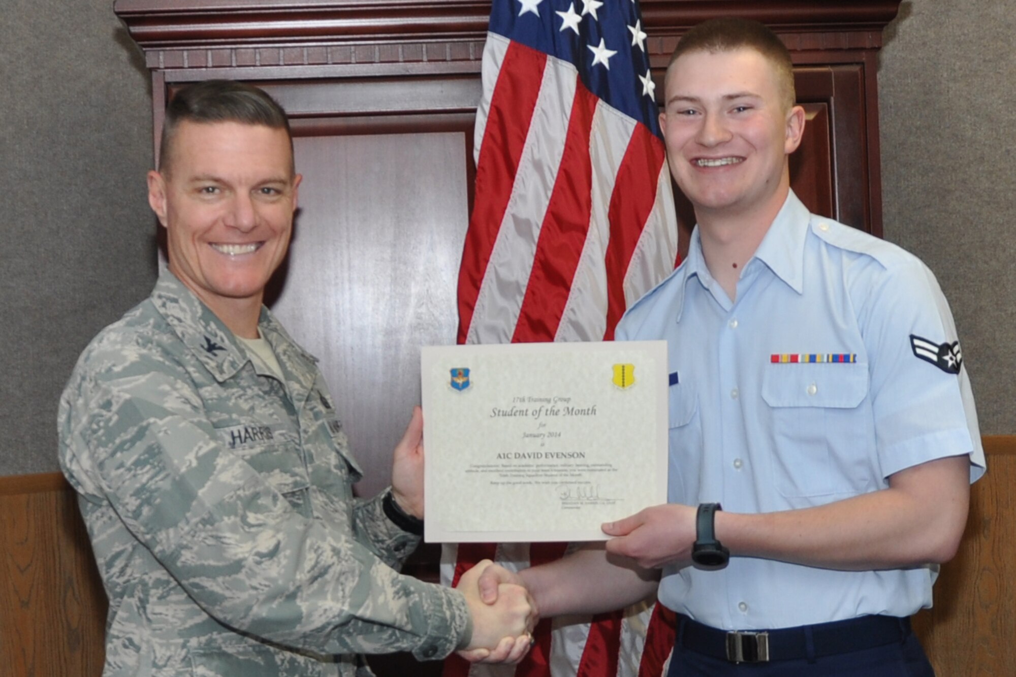 GOODFELLOW AIR FORCE BASE, Texas -- Col. Brendan Harris, 17th Training Group Commander, presents the 316th Training Squadron Enlisted Student of the Month award for January 2014 to Airman 1st Class David Evenson, Feb. 7. (U.S. Air Force photo/Airman 1st Class Breonna Veal)