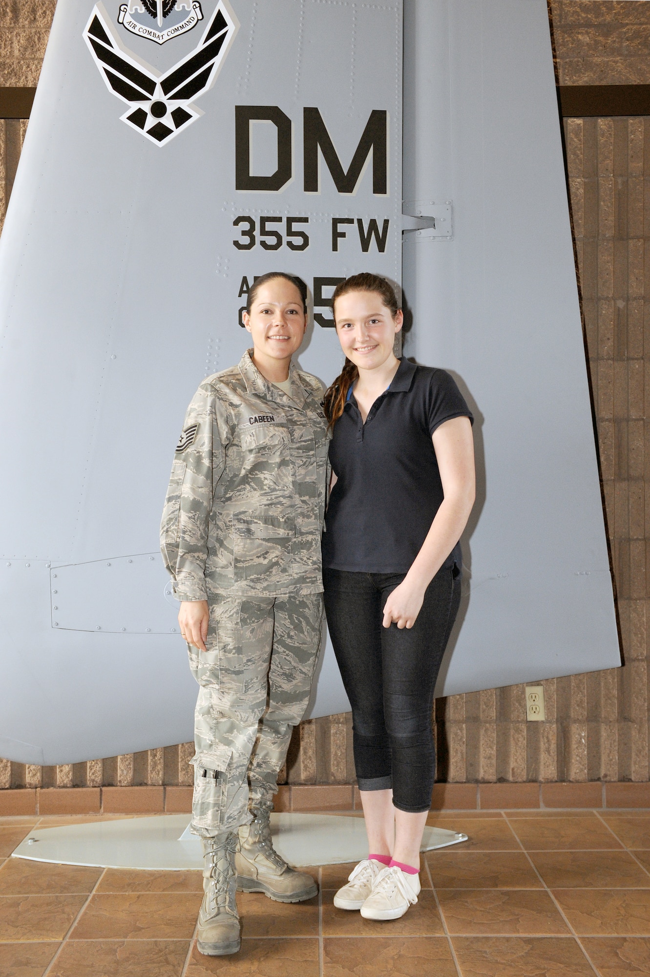 U.S. Air Force Tech. Sgt. Abbi Cabeen, 923rd Aircraft Maintenance Squadron, section chief, and daughter Karrington, semi-finalist for the Military Child of the Year Award, pose for a photo at Davis-Monthan Air Force Base, Ariz., Feb. 5, 2014. Karrington is involved in many extra-curricular activities, to include community service and volunteer work enabling her to be selected as a semi-finalist for the MCOY Award. (U.S. Air Force photo Airman 1st Chris Drzazgowski/Released)