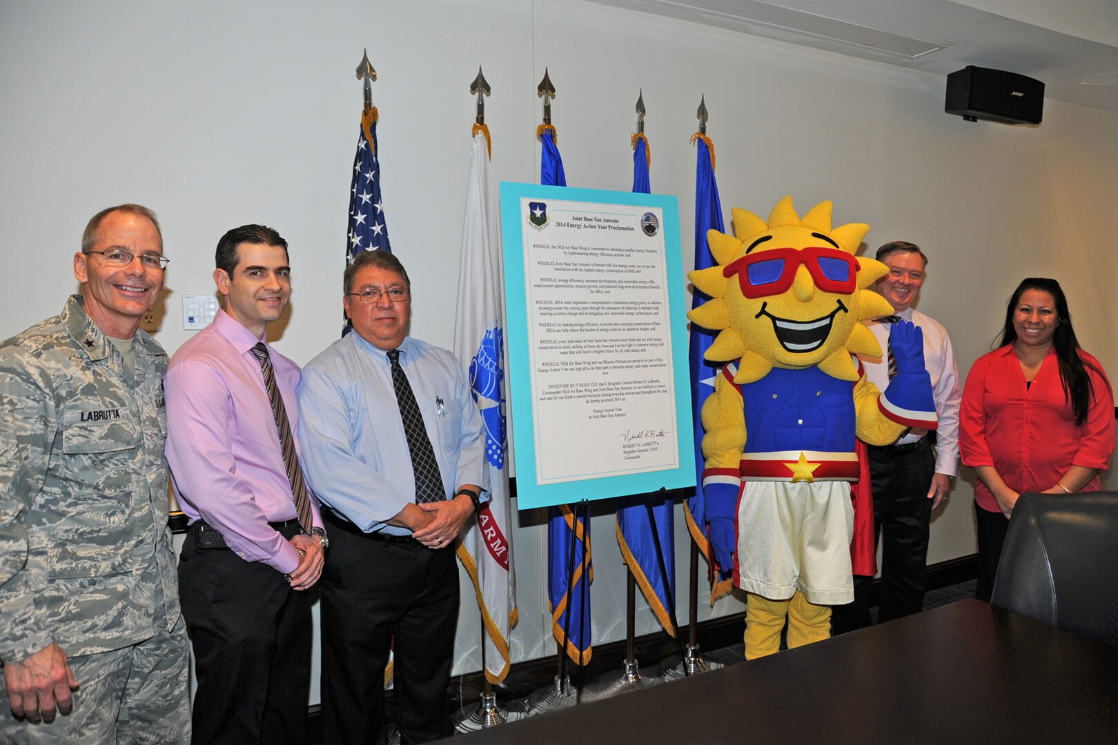 Brig. Gen. Bob LaBrutta (left), 502nd Air Base Wing and Joint Base San Antonio commander, signed a proclamation that designates 2014 as an Energy Action Year in JBSA during a ceremony Feb. 6 at JBSA-Fort Sam Houston. Representing the JBSA energy team at the signing were Ruben Ramos (second from left), JBSA-Randolph energy manager; Andy Hinojosa, JBSA-Lackland energy manager; Ray, the JBSA energy mascot; James Wimberley, JBSA chief of portfolio optimization; and Lauriebeth Smith, JBSA energy manager section chief. (U.S. Air Force Photo by Olivia Mendoza/Released)