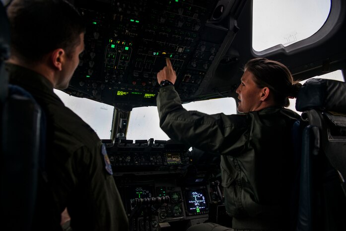 1st Lt. Haley Puffenbarger (right), 17th Airlift Squadron co-pilot, and Capt. Aleks Layne, 17th AS pilot, prepare for a flight Feb. 11, 2014, at Joint Base Charleston – Air Base, S.C. When deployed, the 17th AS will fly multiple missions every day, moving either cargo or personnel. The majority of their missions will be air drops … dropping critical supplies, such as food and ammunition to forward operating bases.  (U.S. Air Force photo/Senior Airman Ashlee Galloway)