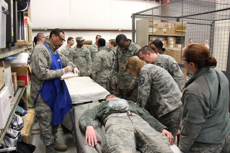 Master Sgt. Deb Teague (second from far right) leads a group of services Airmen through a scenario at the 932nd Airlift Wing.  Tech. Sergeant Van Thompson, NCOIC of food services (far left) assists with keeping a log of the activitiy.  The two day event was meant to refresh their skills in using the Airman's manual, working in teams, and upgrading services-based training.  (U.S. Air Force photo/Maj. Stan Paregien).