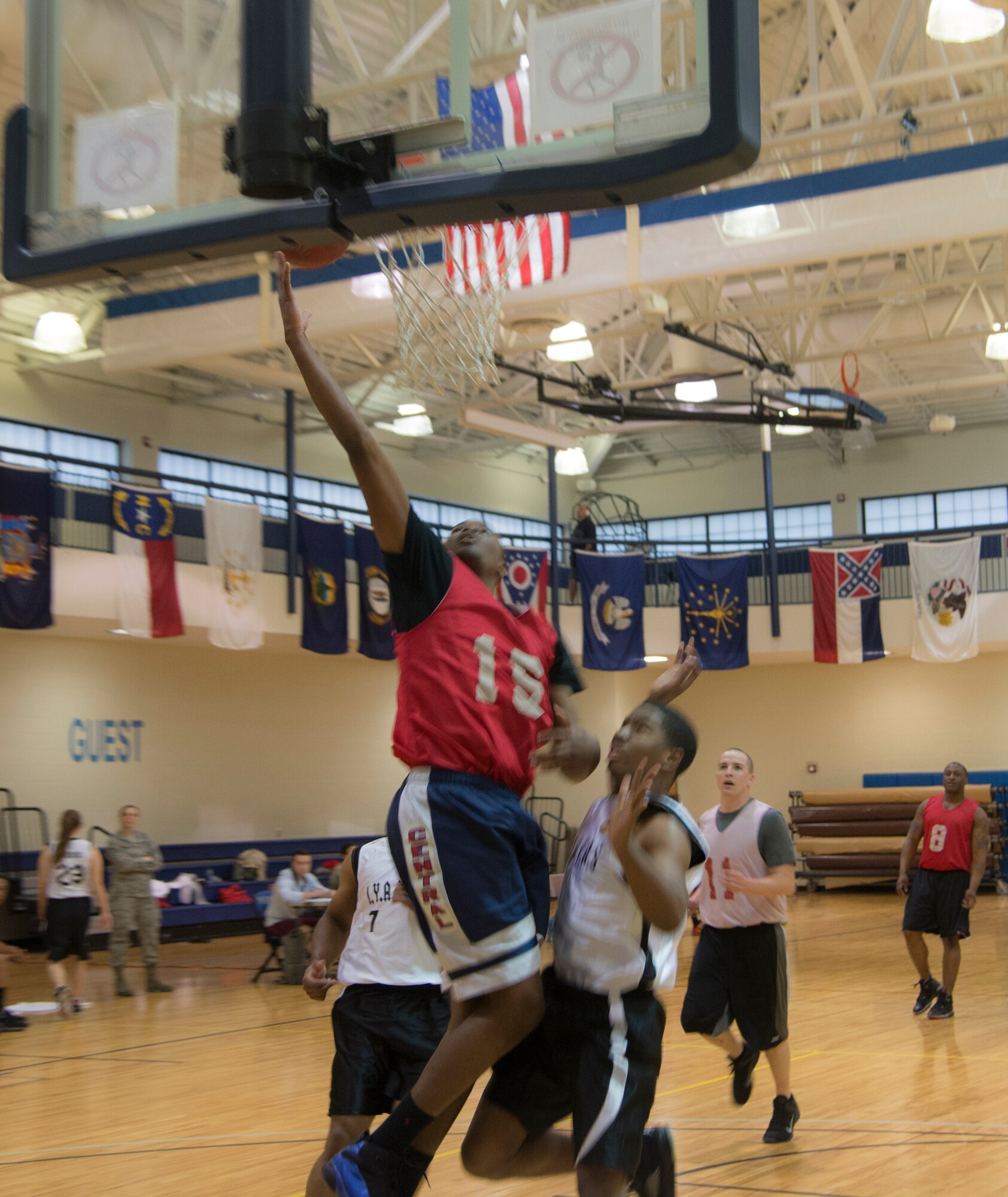 U.S. Air Force Airman 1st Class Joseph Miller, 723d Aircraft Maintenance Squadron, attempts a lay-up during an intramural basketball game at Moody Air Force Base, Ga., Feb. 12, 2014. 723d AMXS blew out 23d Equipment Maintenance Squadron 46-34. (U.S. Air Force photo by Airman Dillian Bamman/Released)