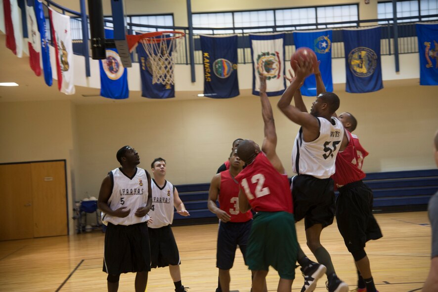 U.S. Air Force Staff Sgt. James Watts, 23d Equipment Maintenance, gets an offensive rebound and attempts a second chance shot during an intramural basketball game at Moody Air Force Base, Ga, Feb. 12, 2014. Watts makes the shot to kick off a 10-point rally for 23d EMS. (U.S. Air Force photo by Airman Dillian Bamman/Released)