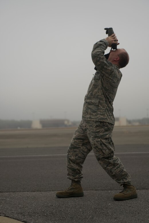 Tech. Sgt. Thomas Burton, 1st Special Operations Support Squadron weather forecaster, looks through a pair of laser range finders on the flightline at Hurlburt Field, Fla., Feb. 12, 2014.  The base weather station uses the range finders to calculate cloud height, which determines mission capabilities for aircraft. (U.S. Air Force photo/Senior Airman Naomi Griego)