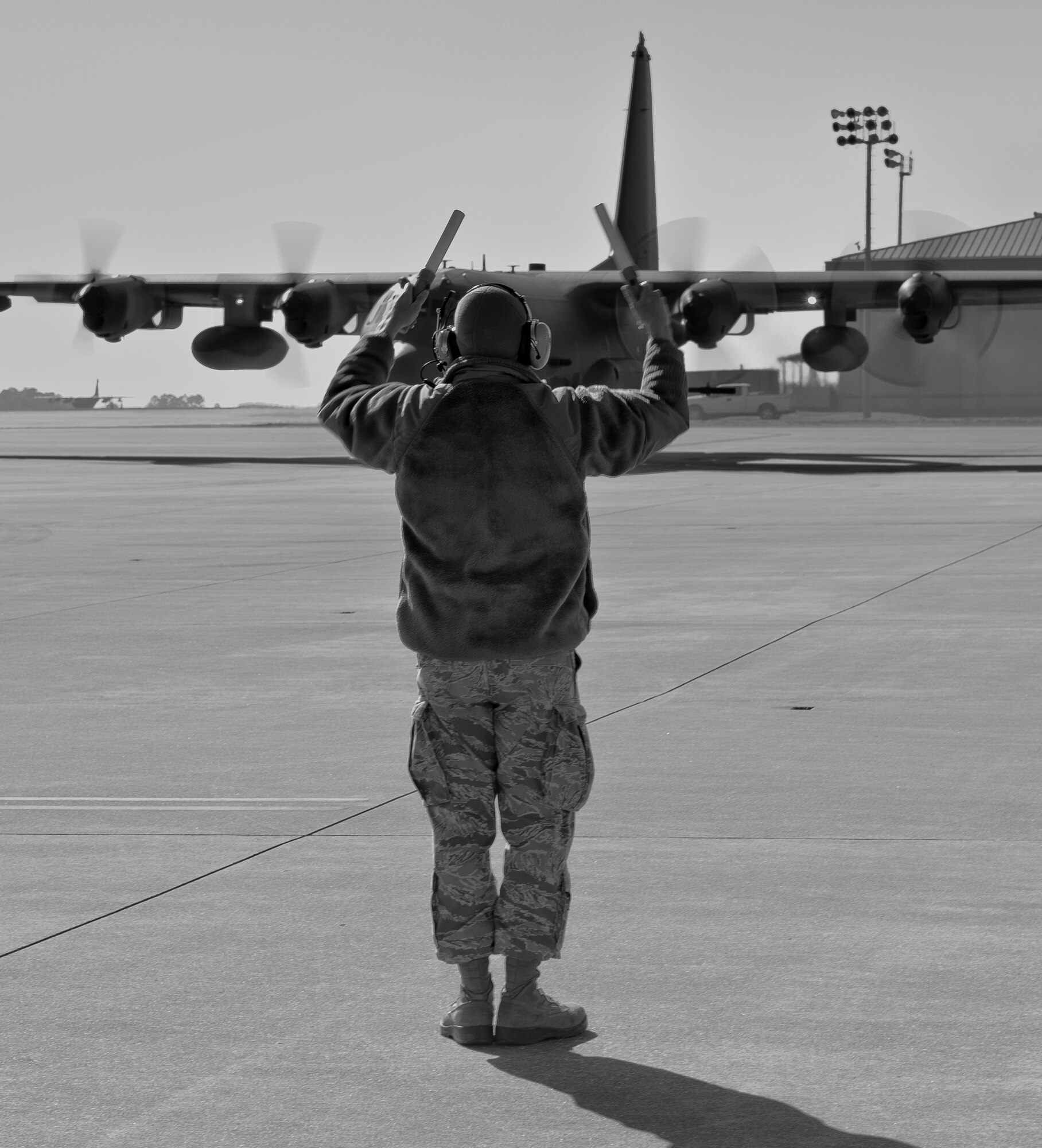 Airman 1st Class Christopher Aubuchon, 1st Special Operations Aircraft Maintenance Squadron crew chief, marshals an AC-130 on the flightline at Hurlburt Field, Fla., Feb. 7, 2014. Marshaling aircraft helps pilots get aircraft off the ground safely. (U.S. Air Force photo/Senior Airman Krystal M. Garrett)