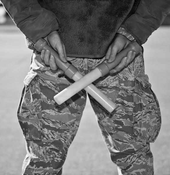 Airman 1st Class Christopher Aubuchon, 1st Special Operations Aircraft Maintenance Squadron crew chief, prepares to marshal an AC-130 on the flightline at Hurlburt Field, Fla., Feb. 7, 2014. Marshaling aircraft helps pilots get aircraft off the ground safely. (U.S. Air Force photo/Senior Airman Krystal M. Garrett)  
