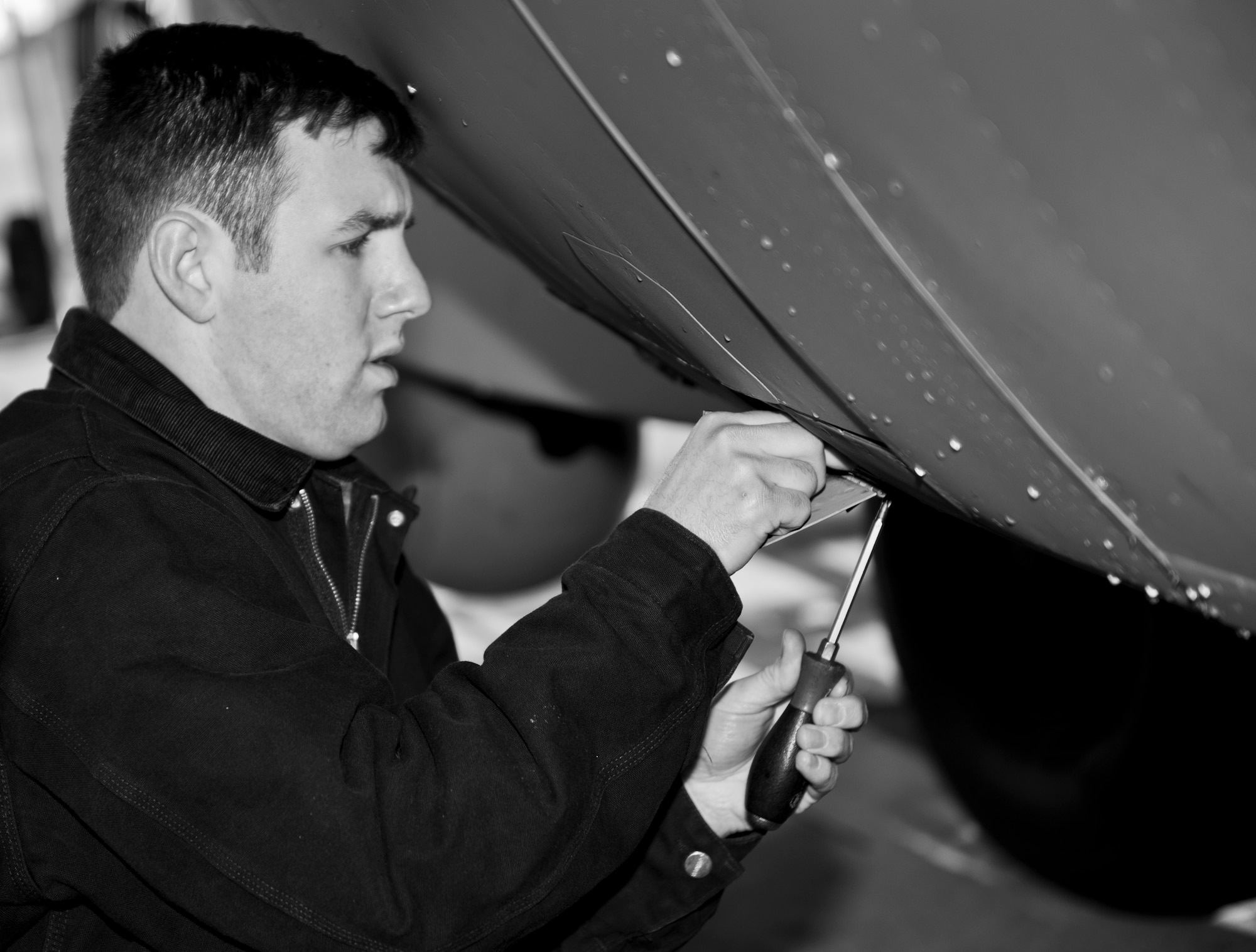 Staff Sgt. Matthew Thorton, 1st Special Operations Aircraft Maintenance Squadron crew chief, repairs an AC-130 crew door on the flightline at Hurlburt Field, Fla., Feb. 7, 2014. Fixing the flap on the crew door allowed the aircrew to open and close the door properly. (U.S. Air Force photo/Senior Airman Krystal M. Garrett) 