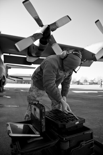 Airman 1st Class Christopher Aubuchon, 1st Special Operations Aircraft Maintenance Squadron crew chief, retrieves tools needed to repair an AC-130 crew door on the flightline at Hurlburt Field, Fla., Feb. 7, 2014. Crew chiefs assist aircrews with maintenance issues before aircraft launch. (U.S. Air Force photo/Senior Airman Krystal M. Garrett) 