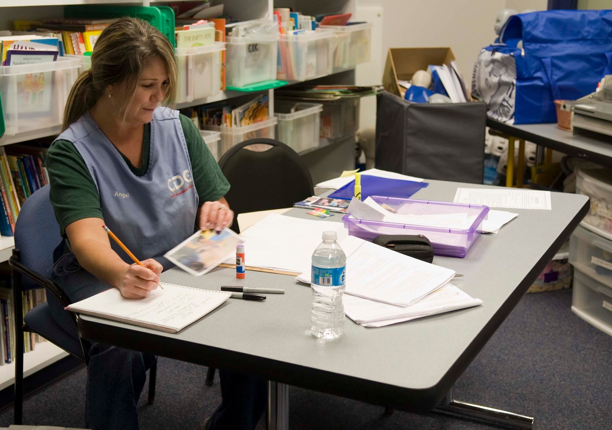 Angel Landry, Dyess Child Development Center staff member, works on an arts and crafts project Feb. 5, 2014, at Dyess Air Force Base, Texas. Landry, along with other members, shows enthusiasm in her job and helps improve the CDC mission each day by improving several different programs based on ages of the children and their needs. (U.S. Air Force photo by Airman 1st Class Kylsee Wisseman/Released) 