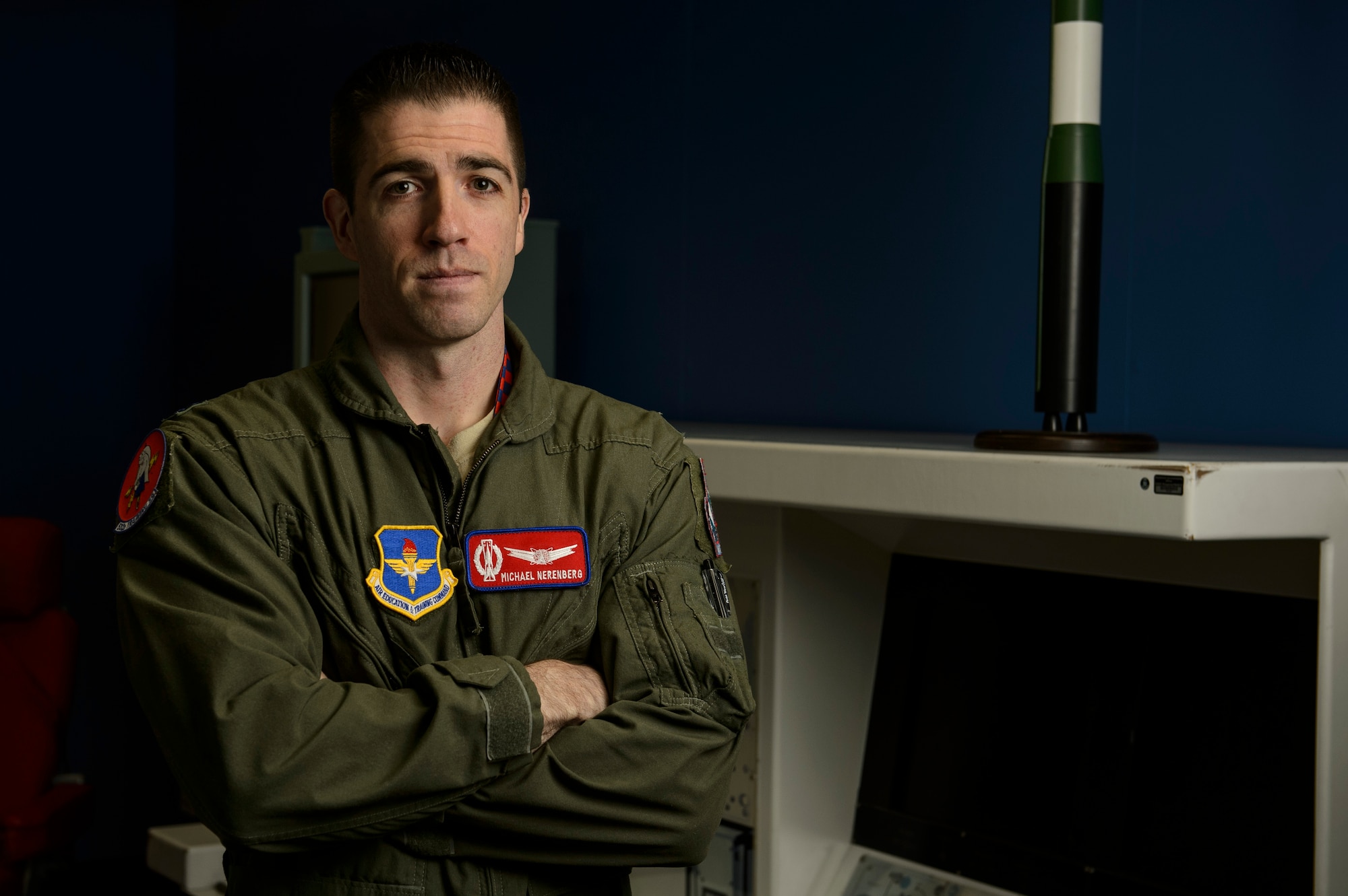 Capt. Michael Nerenberg, 532nd Training Squadron Intercontinental Ballistic Missile electronic weapons officer operations instructor, poses for a photo in a missile procedure trainer room at Vandenberg Air Force Base, Calif., Feb. 4, 2014. The 532nd TRS train and educate more than 180 missileer graduates every year. (U.S. Air Force photo by Staff Sgt. Jonathan Snyder/RELEASED)

