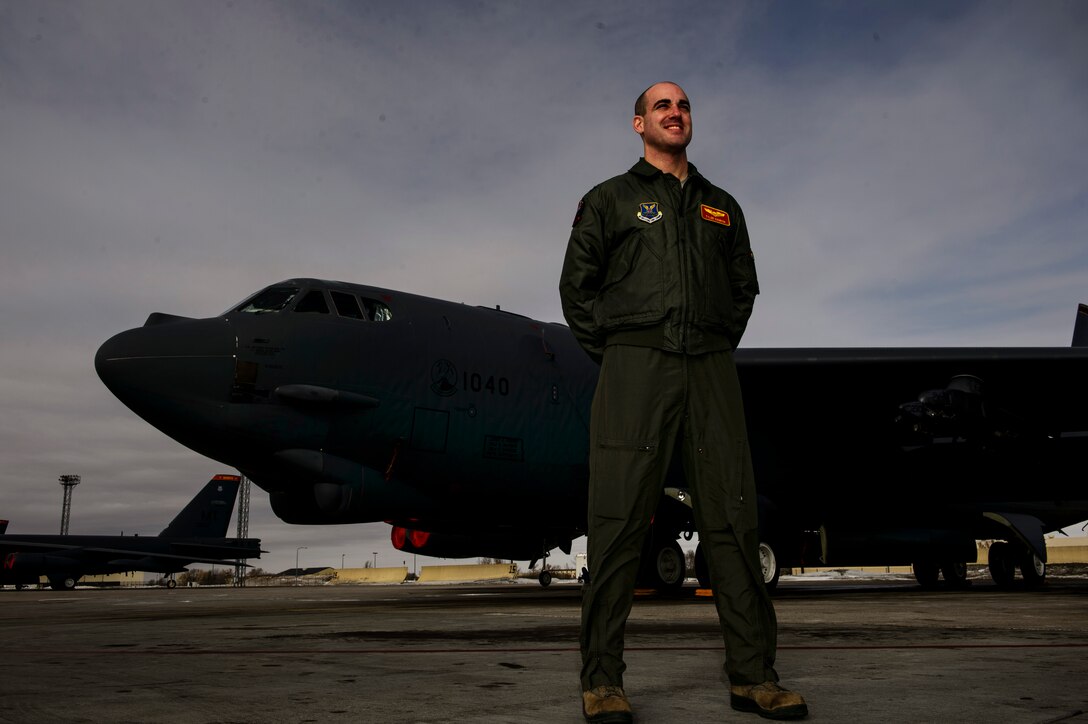 Capt. Tyler Hanrion, 23rd Bomb Squadron co-pilot, poses in front of a B-52H Stratofortress at Minot Air Force Base, N.D., Feb. 12, 2014. The B-52 is capable of flying at high subsonic speeds at altitudes up to 50,000 feet. It can carry a variety of weapons including nuclear and precision guided conventional ordnance with worldwide precision navigation capability. (U.S. Air Force photo by Staff Sgt. Jonathan Snyder/RELEASED)

