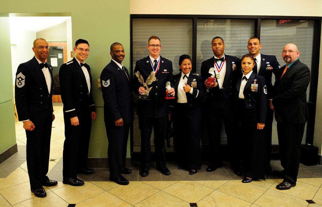 Airman First Class Kenley Lott (center), 9th Mission Support Group, holds his Volunteer of the Year awards for the 9th Reconnaissance Wing and Team Beale categories at the 2013 annual awards ceremony at Beale Air Force Base, Calif., Feb. 7, 2014. Lott is just one of many Airmen who have given back to the community through volunteering. (U.S. Air Force photo by Airman 1st Class Bobby Cummings/Released)