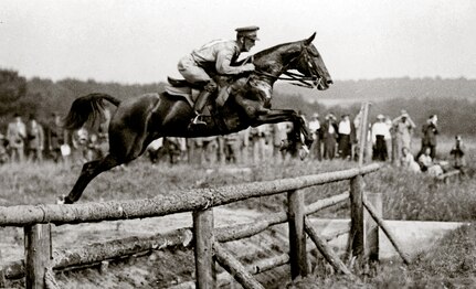 Courtesy photo
Army Lt. George C. Patton jumping an obstacle during the equestrian segment of the Modern Pentathlon at the 1912 Olympic Games
in Stockholm, Sweden. The original Modern Pentathlon required each competitor to ride an unfamiliar horse over a 5,000-meter
wooded obstacle course. Patton was the lone American competitor for Modern Pentathlon and placed fifth overall.