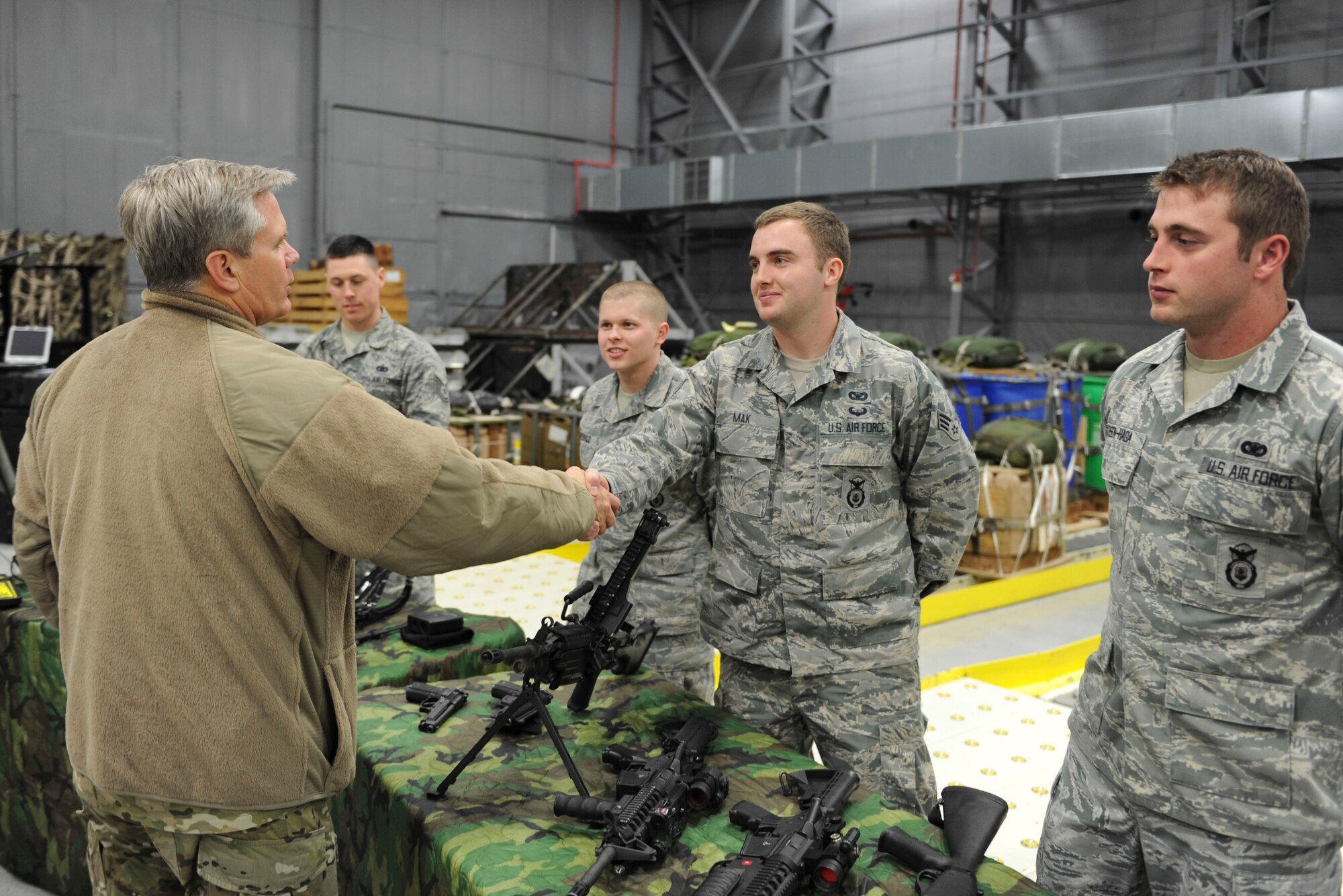 Lt. Gen. Eric Fiel, Air Force Special Operations Command commander (left), shakes hands with U.S. Air Force Senior Airman Joshua Mak, 352nd Special Operations Support Squadron Deployed Aircraft Ground Response Element, Feb. 11, 2014, during Fiel’s visit to RAF Mildenhall, England. Fiel met with Airmen assigned to the 352nd Special Operations Group and toured different facilities used by the group. (U.S. Air Force photo by Staff Sgt. Stephen Linch)