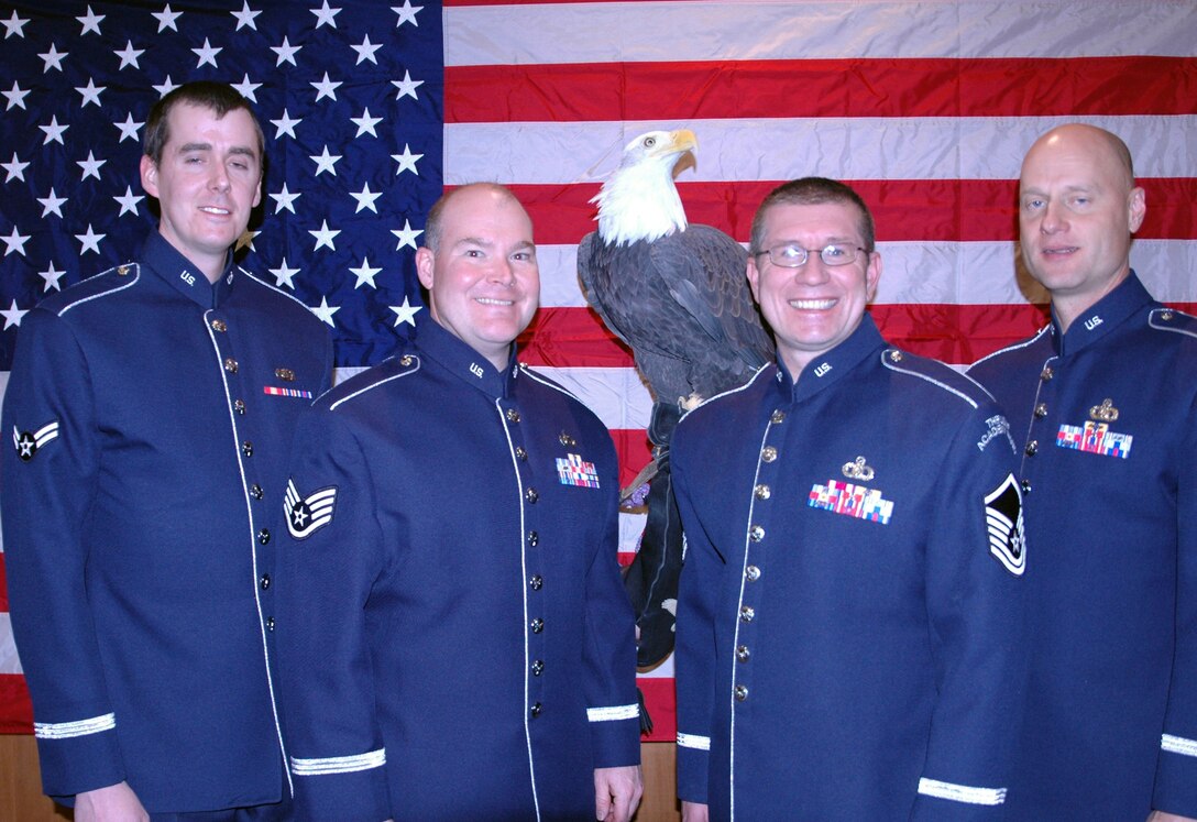 (Left to right) A1C Shawn Hanlon, SSgt Jeff Hall, MSgt Jason Crowe, and MSgt Tim Blake visit with a bald eagle during their break at the State of the Aerospace Data Facility, Colorado (ADF-C) Address on January 25th at Wildlife Experience in Parker, CO.