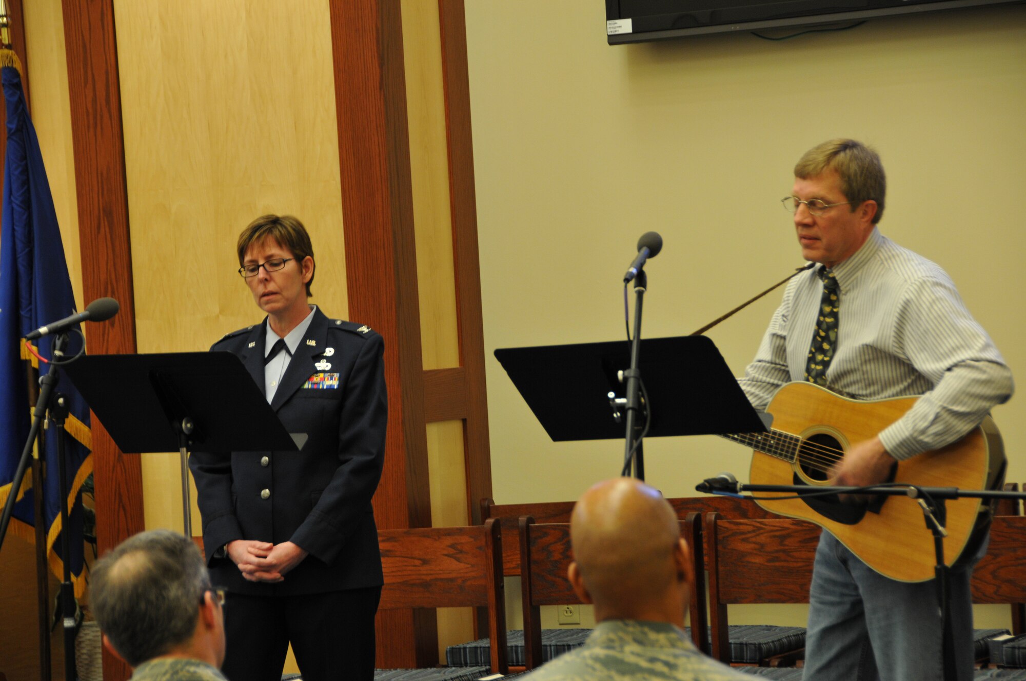 Col. Gretchen Wiltse, 512th Mission Support Group commander, and Mike Rudis, the base choir director for the Catholic services, sing a song of reflection during a memorial service for Senior Airman Alberto Feb. 8, 2014 at Chapel 1, Dover Air Force Base, Del. The service was attended by Soto’s wife Sherry and about 100 512th Airlift Wing reservists. (U.S. Air Force photo/Senior Airman Joe Yanik)