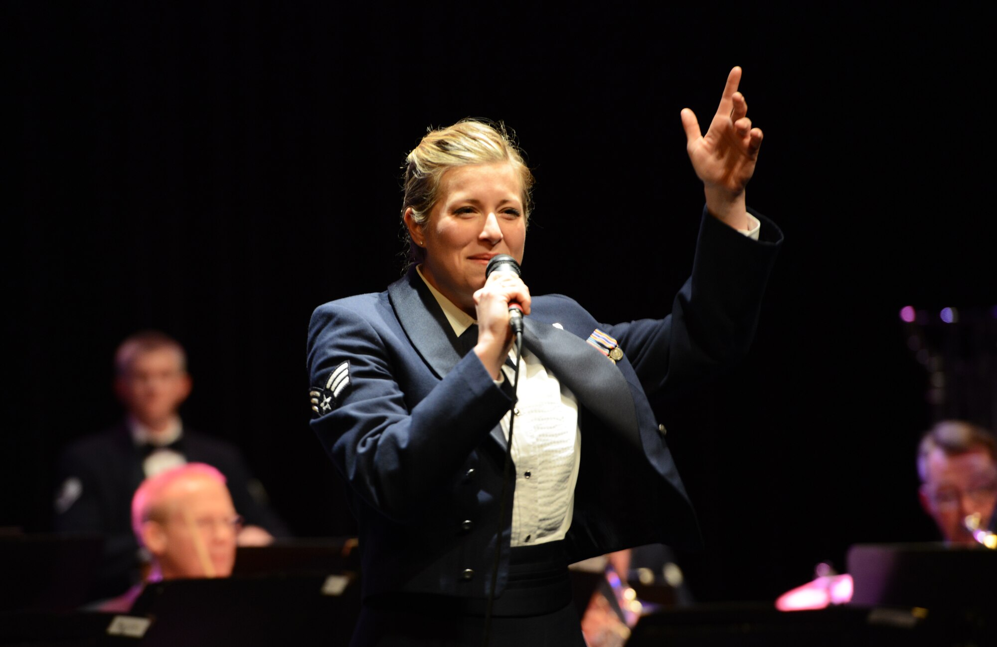Senior Airman Carmen Emborski, U.S. Air Force in Europe and Air Forces Africa Band vocalist, sings during a joint military performance Feb. 10, 2014, Pont-A-Mousson, France. The bands came together to conduct five concerts in five days across Europe to foster cultural relations and promote international diplomacy. (U.S. Air Force photo/Airman Dymekre Allen)