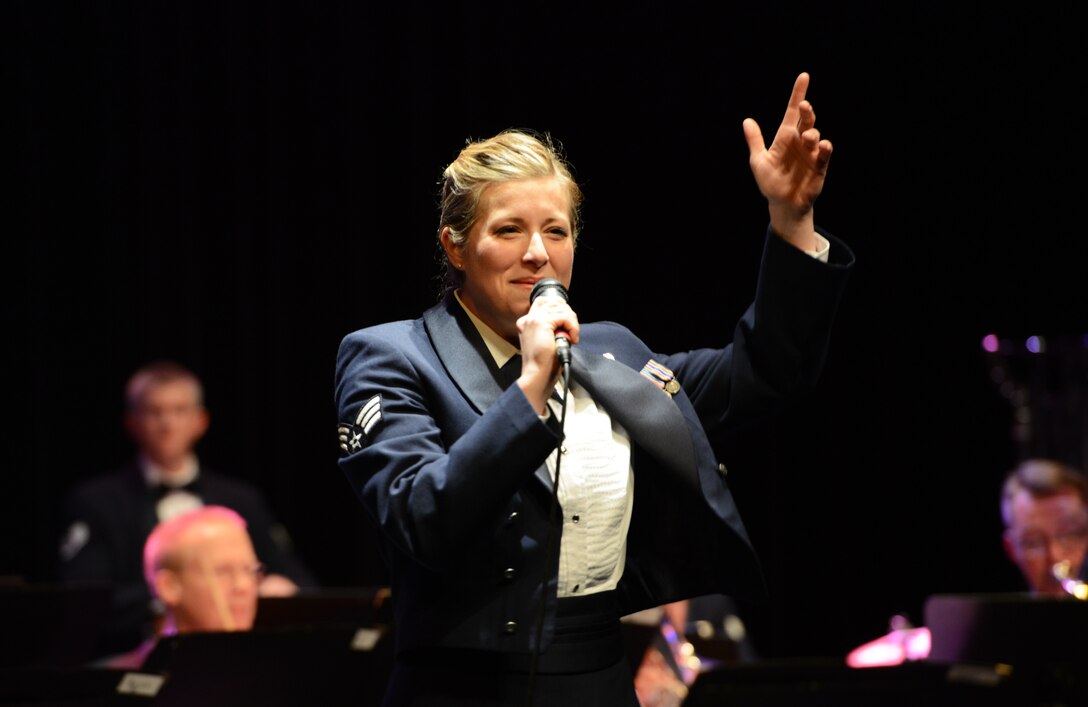Senior Airman Carmen Emborski, U.S. Air Force in Europe and Air Forces Africa Band vocalist, sings during a joint military performance Feb. 10, 2014, Pont-A-Mousson, France. The bands came together to conduct five concerts in five days across Europe to foster cultural relations and promote international diplomacy. (U.S. Air Force photo/Airman Dymekre Allen)