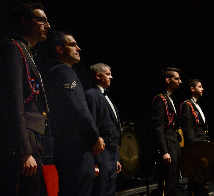 Members of the U.S. Air Force in Europe and Air Forces Africa Band and the Luxemburg Military stand for an applause from the audience Feb. 10, 2014, Pont-A-Mousson, France. The bands came together to conduct five concerts in five days across Europe to foster cultural relations and promote international diplomacy. (U.S. Air Force photo/Airman Dymekre Allen)