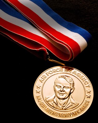 Technical Sgt. Aaron Leger of the 101st Intelligence Squadron receives a gold medal from Air Force ISR Agency in the Maj. Gen. Doyle E. Larson Awards program. The coveted competition identifies, recognizes and honors the “Best of the Best” performers in 25 job specialties found at cryptologically-linked and administratively supported units from active duty Air Force, Air Force Reserves and Air National Guard.(U.S. Air Force photos by Mr. William Belcher/Released)