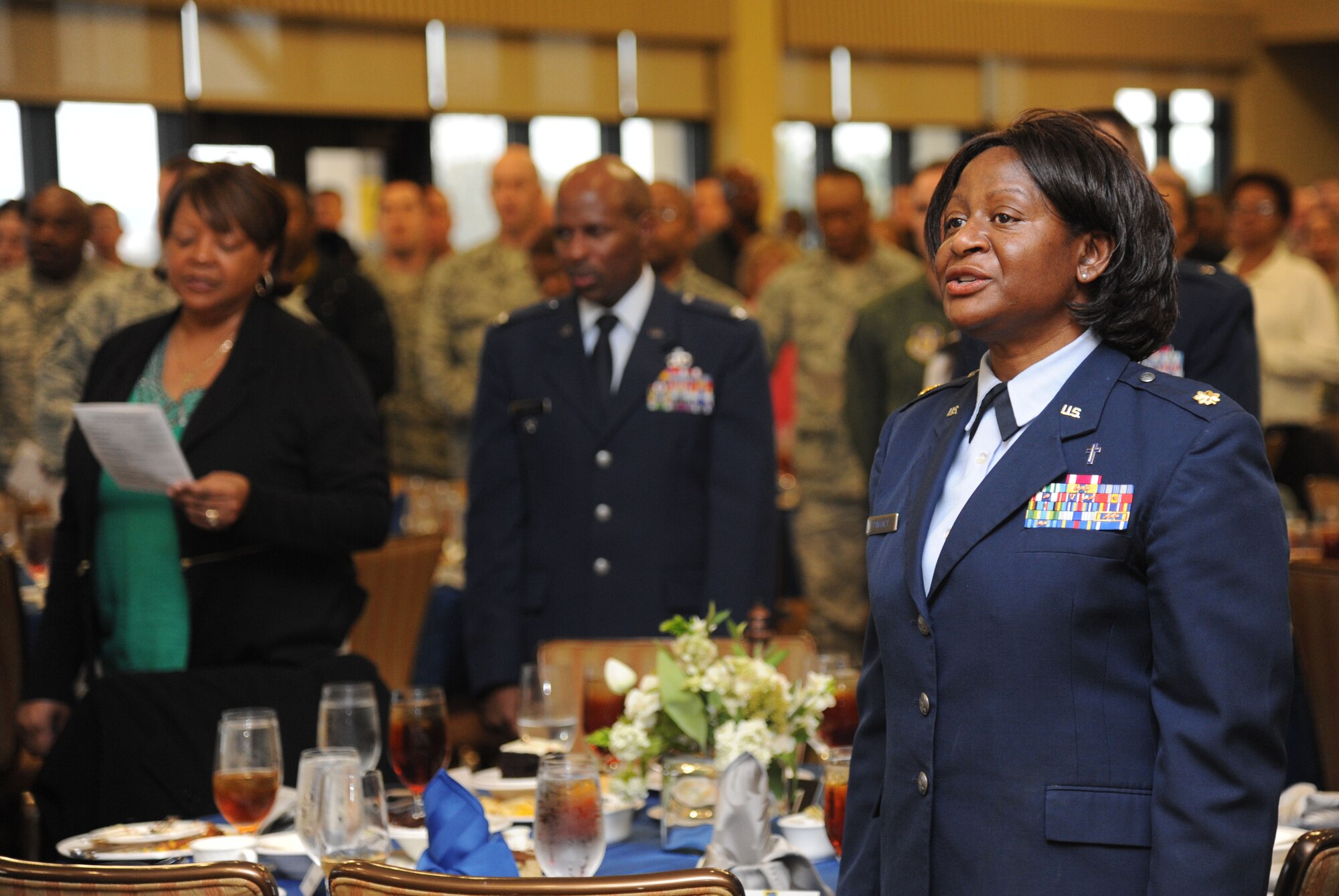 Chaplain (Maj.) Josephine Pinkney, 81st Training Wing, joins the audience to sing “God Bless America” during the National Prayer Luncheon Feb. 12, 2014, at the Bay Breeze Event Center, Keesler Air Force Base, Miss.  The annual event, a tradition that stems back to President Dwight D. Eisenhower in 1953, allows individuals of different faiths and backgrounds to join together to reflect and develop their spiritual fitness. This year’s theme was “One Voice, United in Prayer.”  (U.S. Air Force photo by Kemberly Groue)
