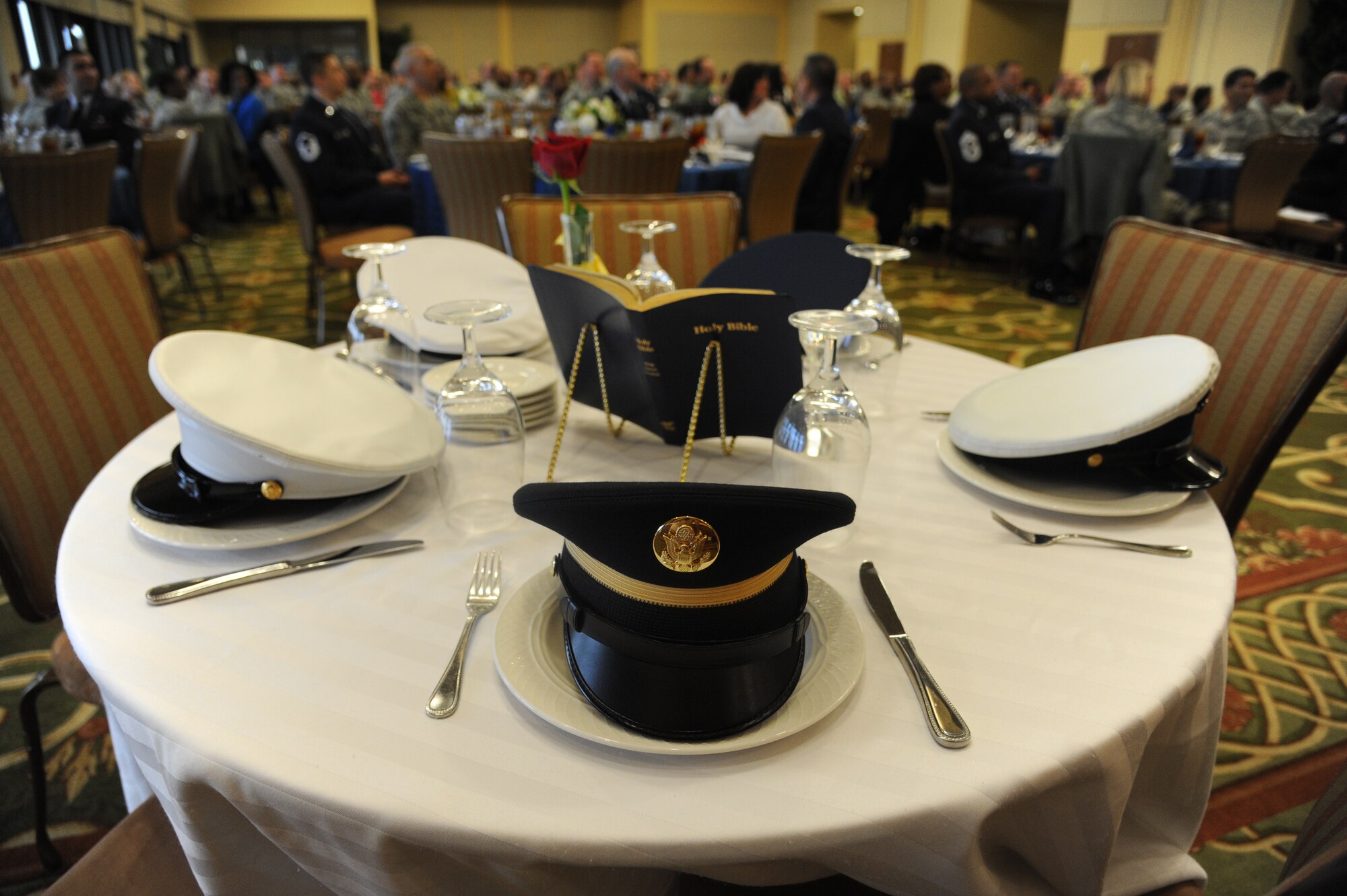 A table honoring prisoners of war and those missing in action sits at the front of the room following a ceremony performed by the Keesler Honor Guard during the National Prayer Luncheon Feb. 12, 2014, at the Bay Breeze Event Center, Keesler Air Force Base, Miss.  The annual event, a tradition that stems back to President Dwight D. Eisenhower in 1953, allows individuals of different faiths and backgrounds to join together to reflect and develop their spiritual fitness. This year’s theme was “One Voice, United in Prayer.”  (U.S. Air Force photo by Kemberly Groue)
