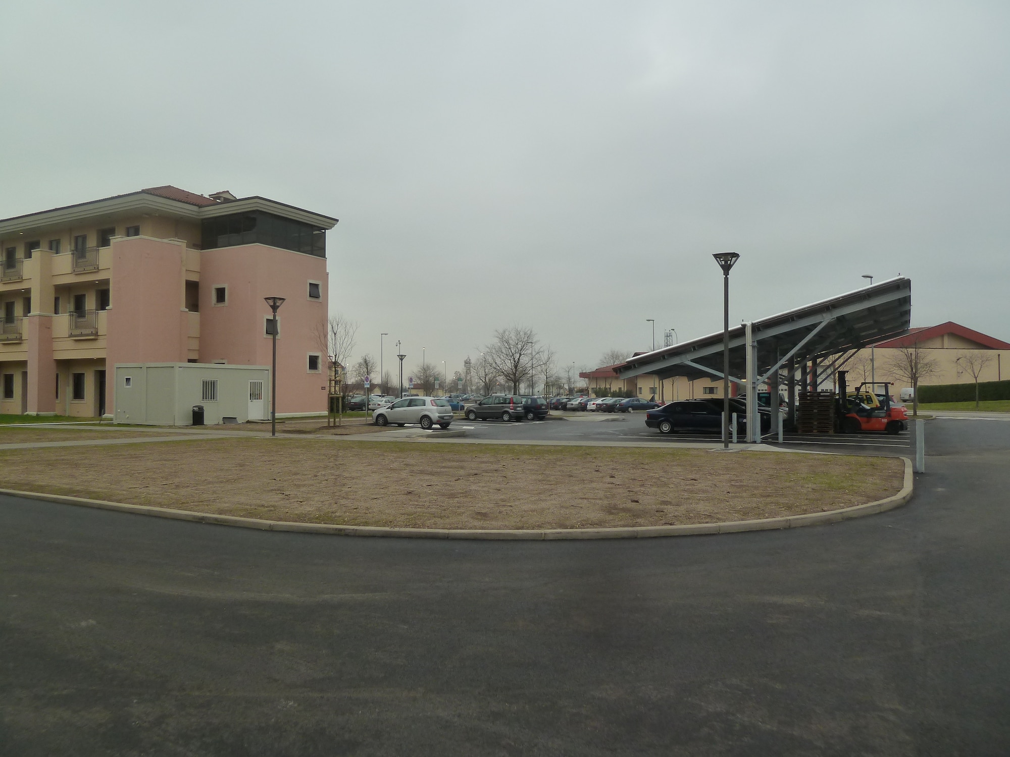 AVIANO AIR BASE, Italy -- The Air Force Civil Engineer Center recently completed construction of a $15.4 million dormitory here. The new three-story dorm houses 144 Airmen and includes such energy saving features as a solar-powered hot water system which will save $4000 annually and double as a shade canopy for parking. (U.S. Air Force photo)