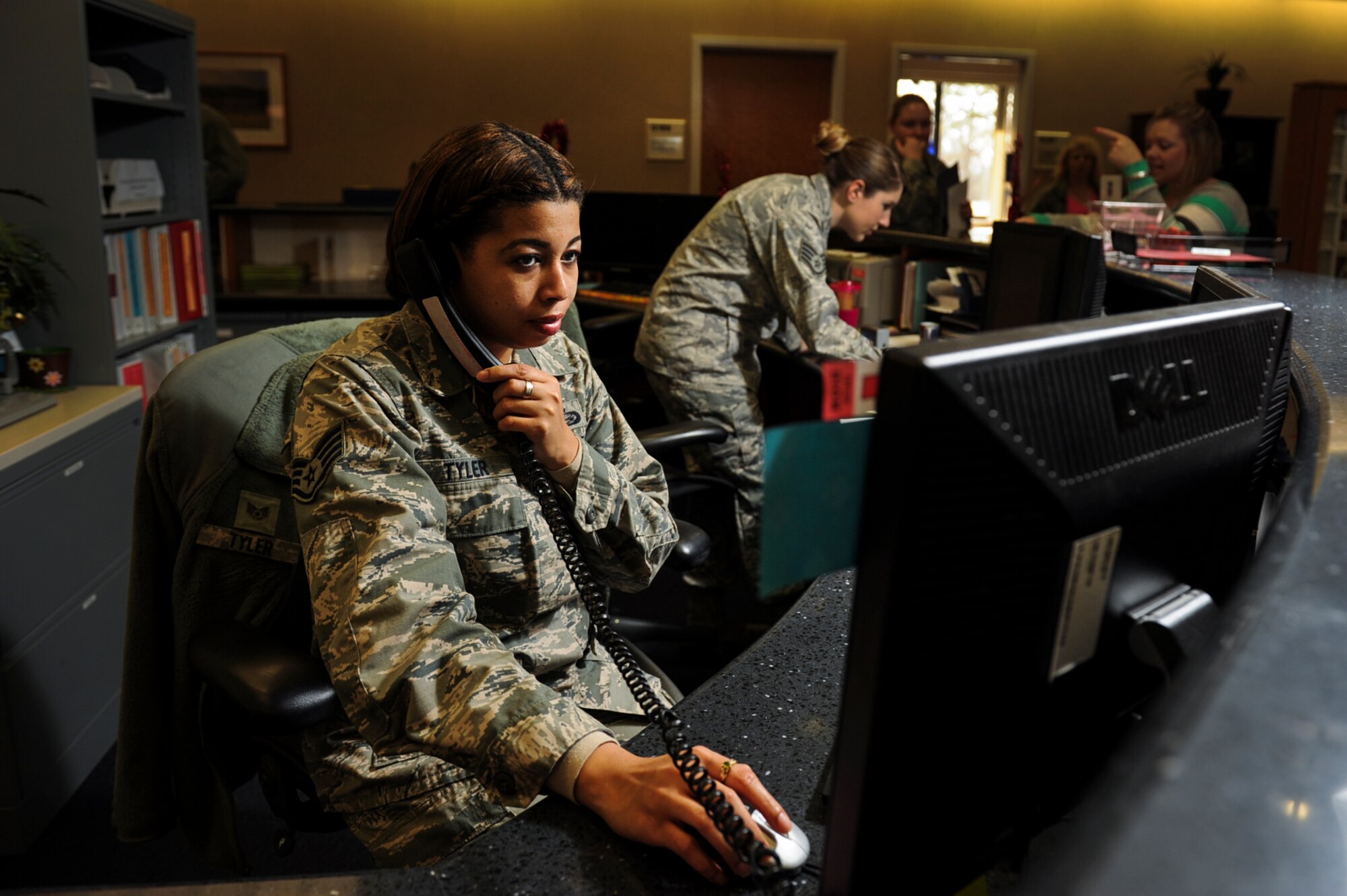 Staff Sgt. Kimberly Tyler, the19th Medical Support Squadron non commisioned officer in charge of commander support staff, assists an Airman with the activation of their government travel card, Feb. 10, 2014, at Little Rock Air Force Base, Ark. Tyler oversaw the tracking and review of more than 250 evaluations and decorations with a 97-percent on-time completion rate, leading the 19th Airlift Wing. (U.S. Air Force photo by Airman 1st Class Cliffton Dolezal) 